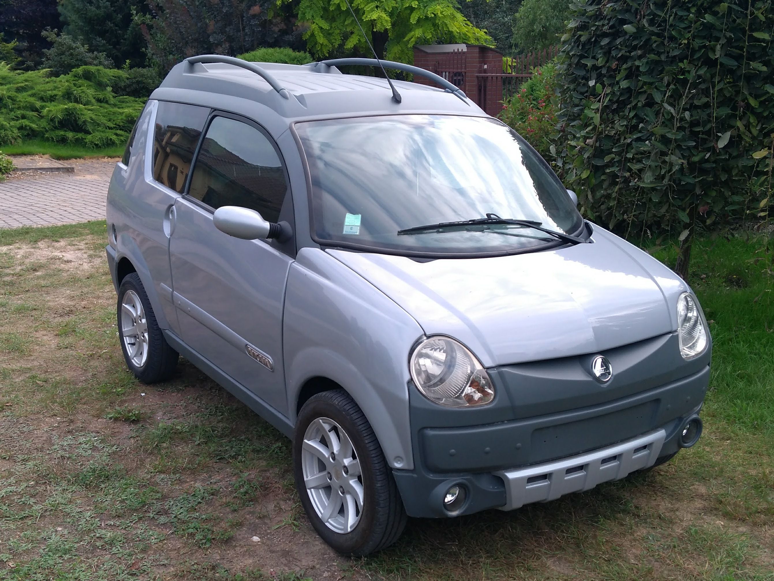 Silver Aixam Crossline first-generation microcar, front three-quarter view
