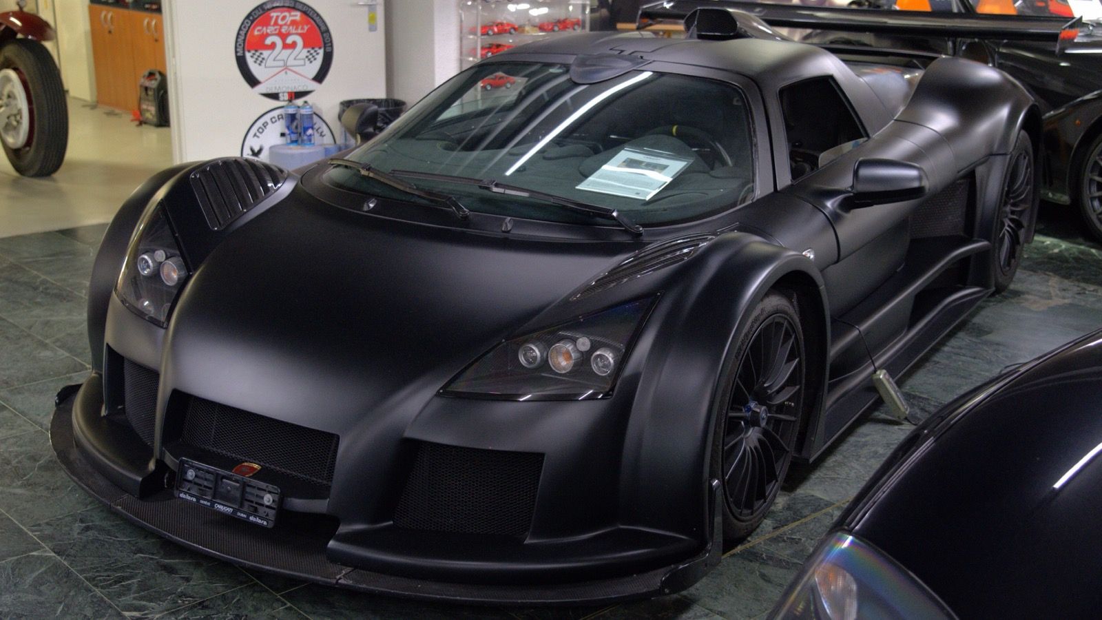 Matte black Gumpert Apollo Sport, front three-quarter view