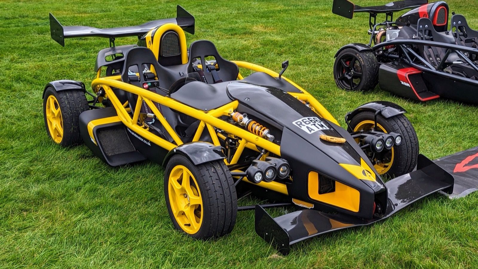 Yellow and black Ariel Atom 3.5R with rear wing, front three-quarter view