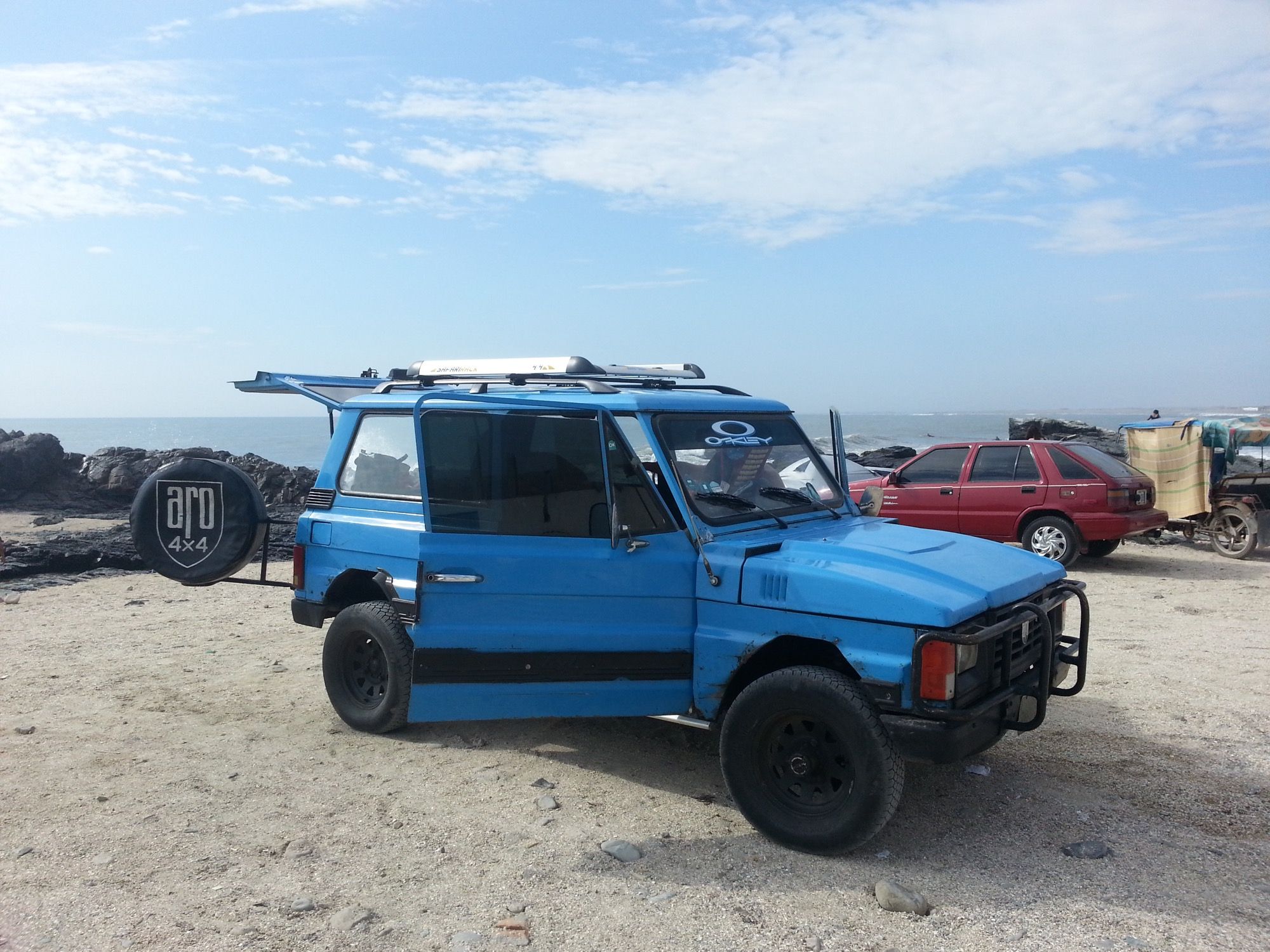 ARO 10.4 three-door hard-top 4x4 in blue on a beach, front three-quarter view