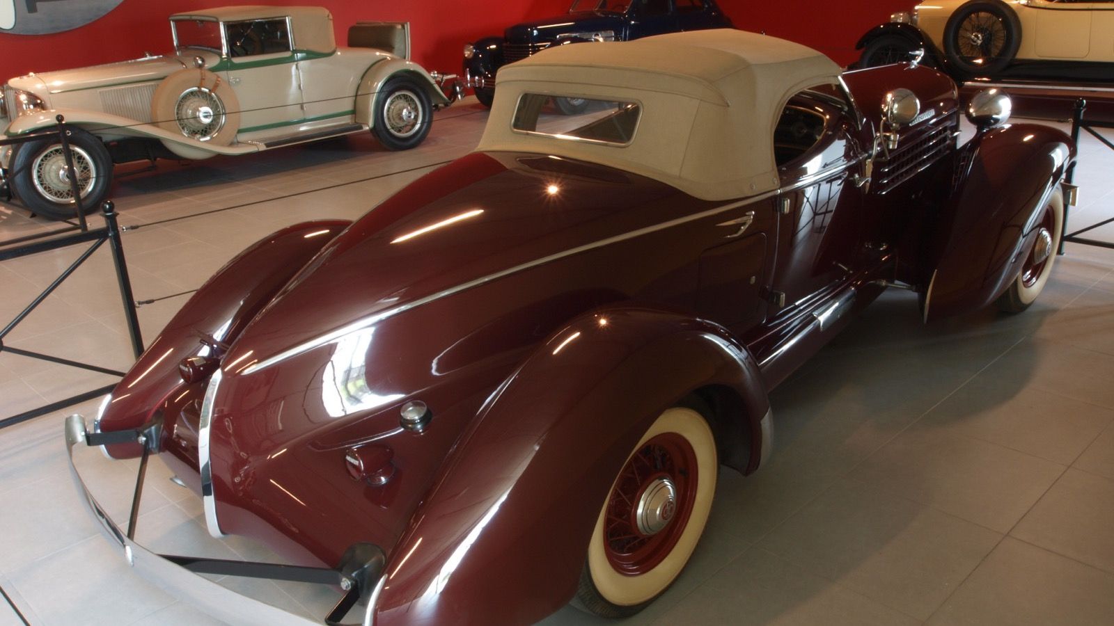 1936 Auburn 852 boat-tail Speedster in maroon, rear three-quarter view showing the boat tail