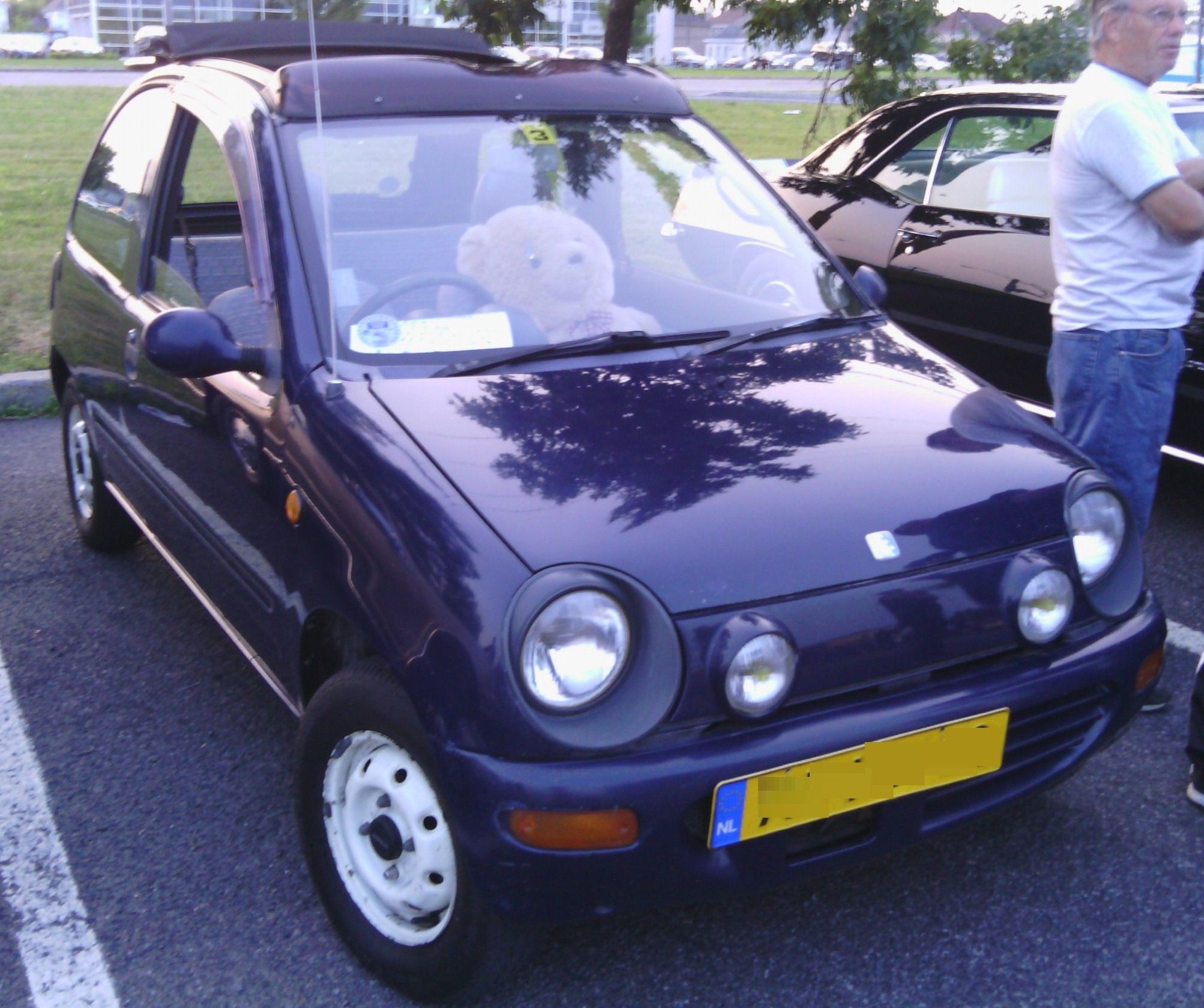 Dark blue 1989 Autozam Carol with canvas top, front three-quarter view