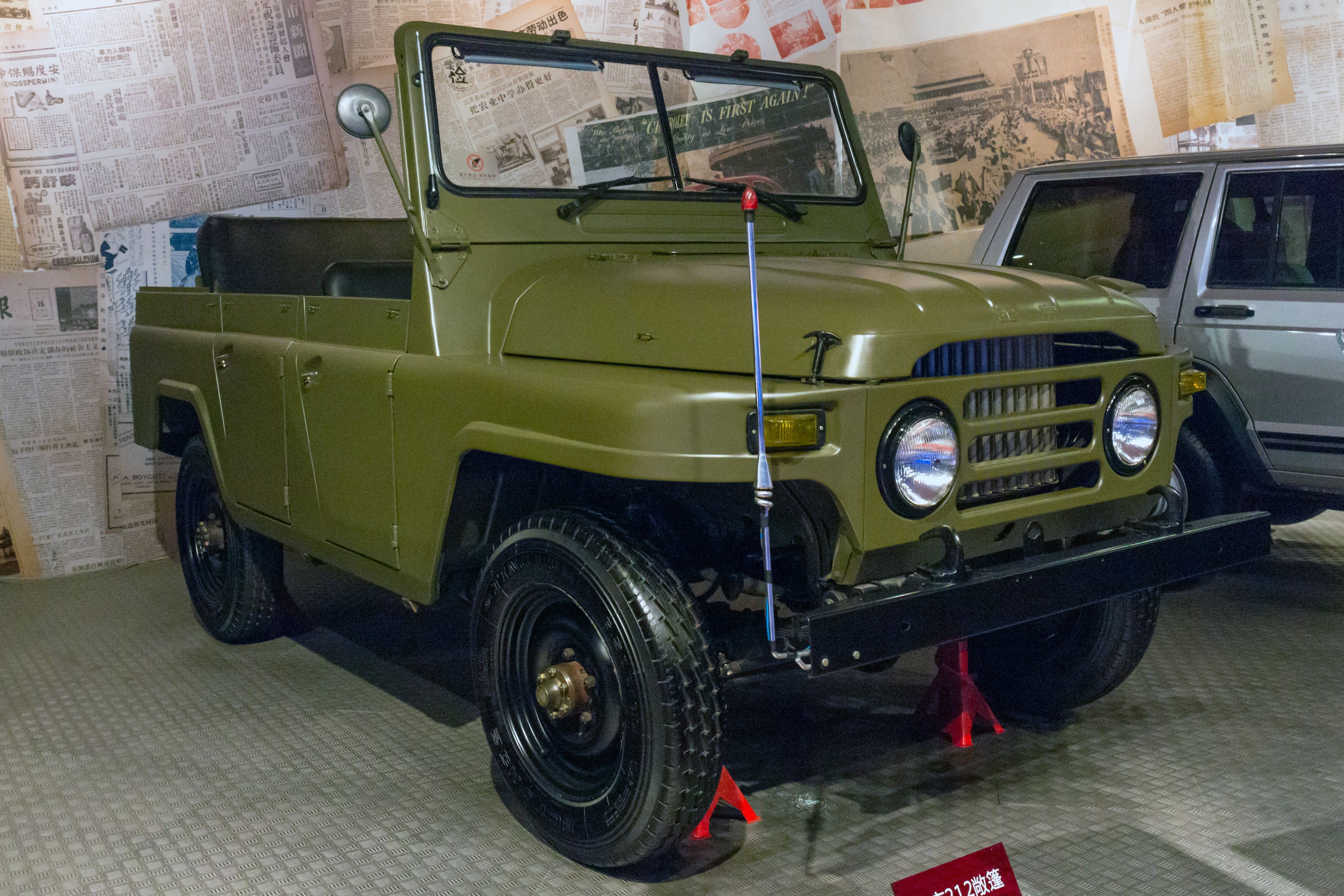 Army-green open-top first-generation BAIC BJ212 military jeep, front three-quarter view