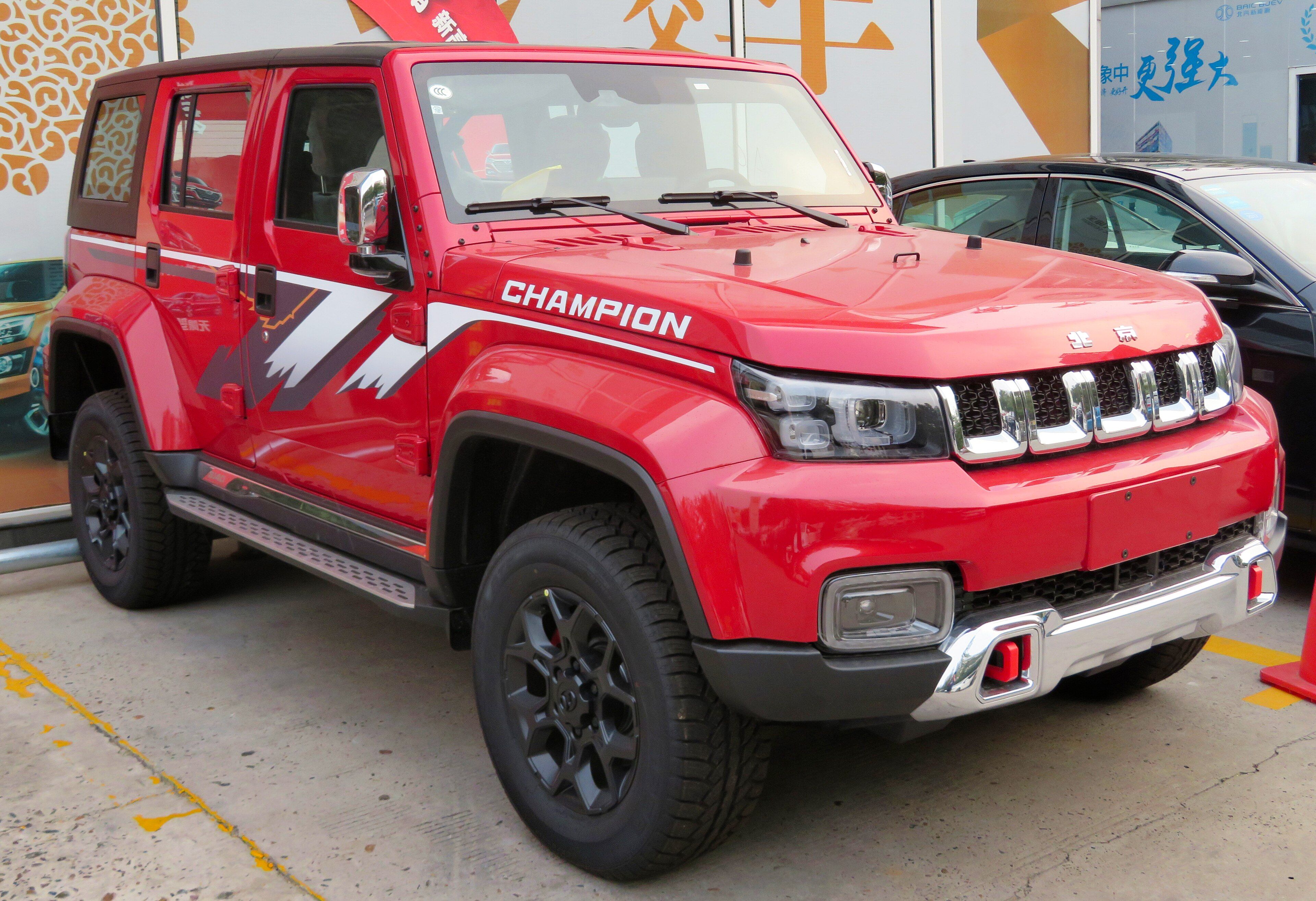 Red 2018 BAIC Beijing BJ40 Plus four-door SUV, front three-quarter view