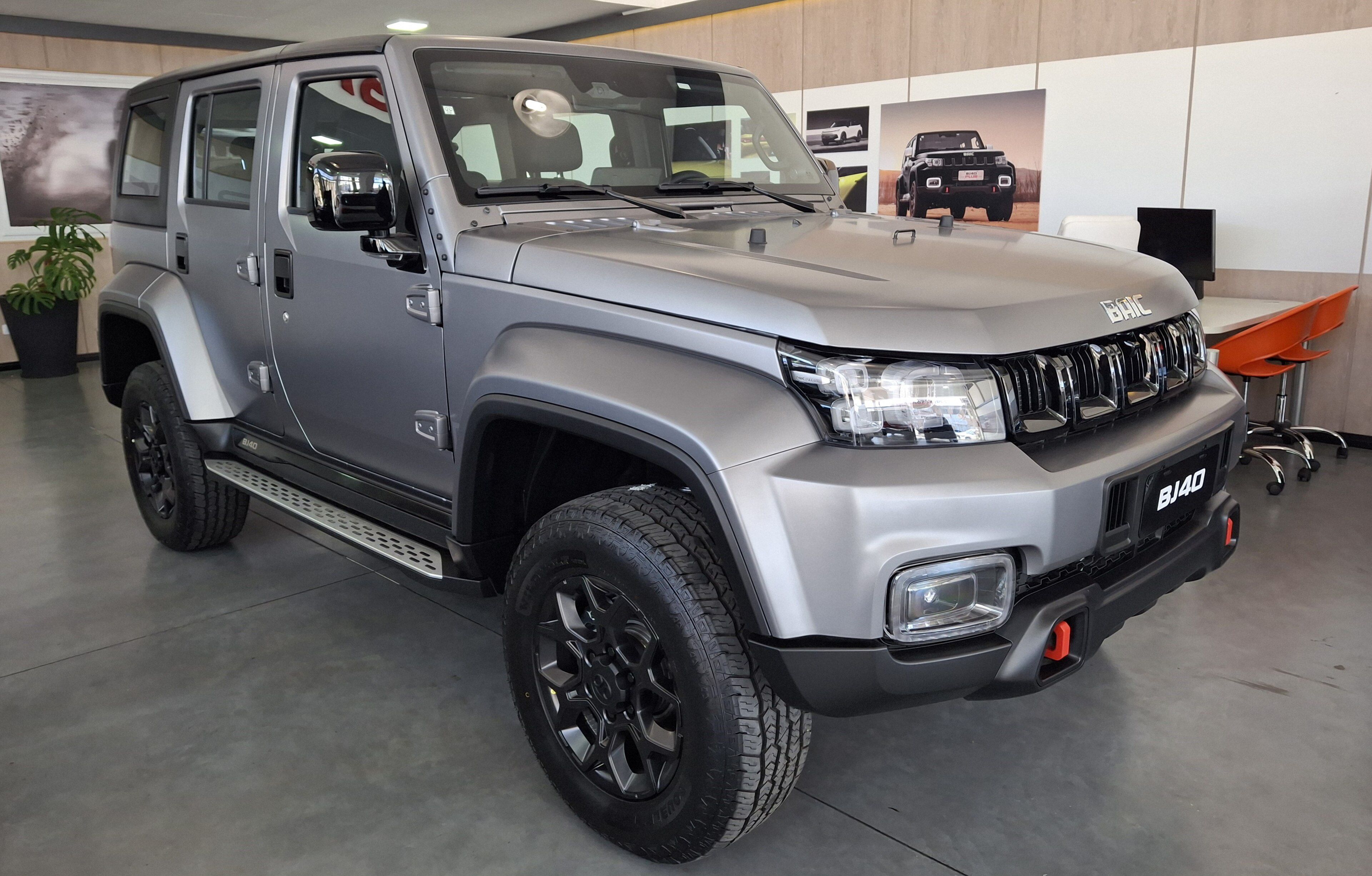 Silver 2025 BAIC BJ40 four-door SUV in a showroom, front three-quarter view