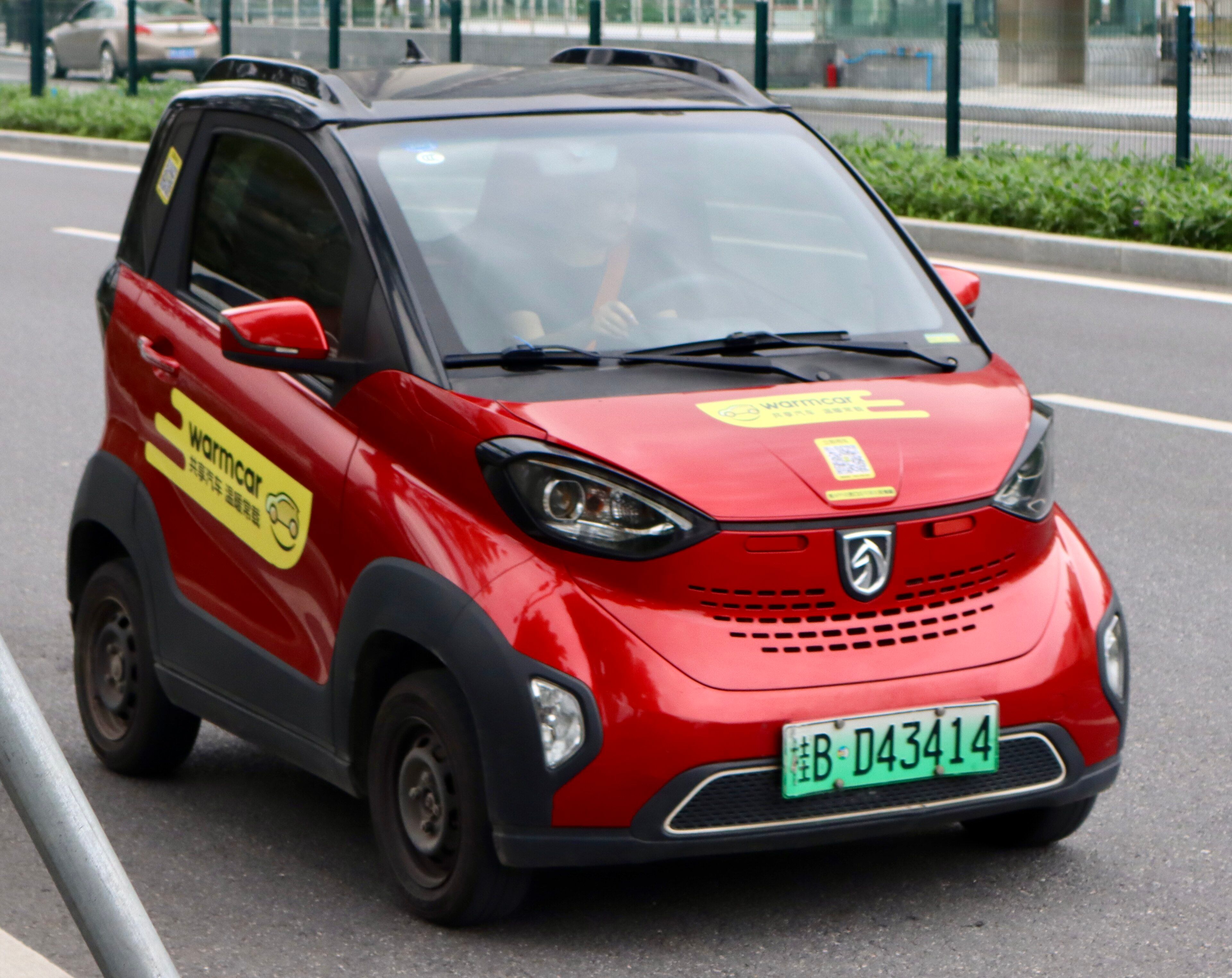 Red Baojun E100 two-seat electric microcar, front three-quarter view