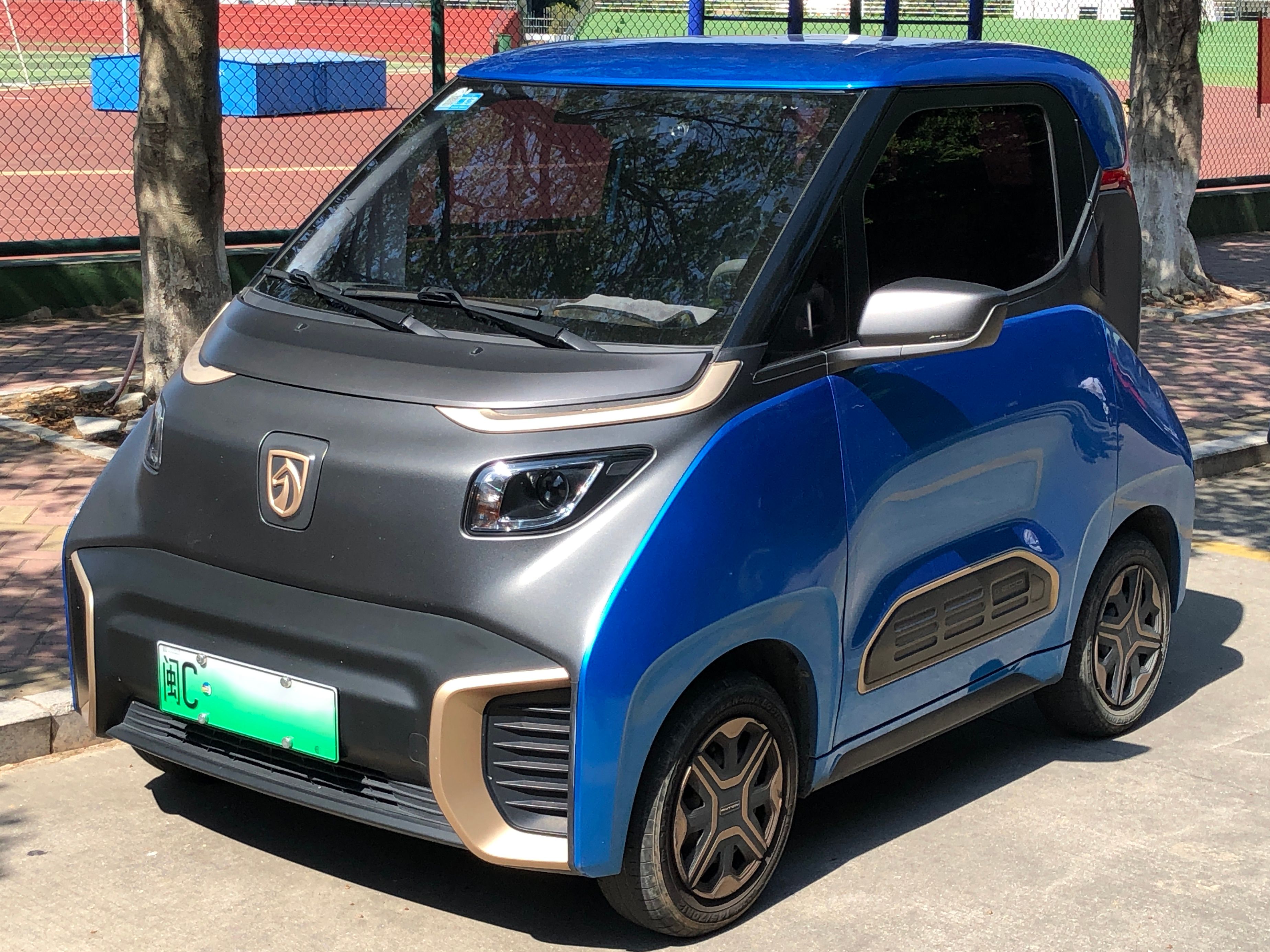 Blue and grey Baojun E200 two-seat electric microcar, front three-quarter view
