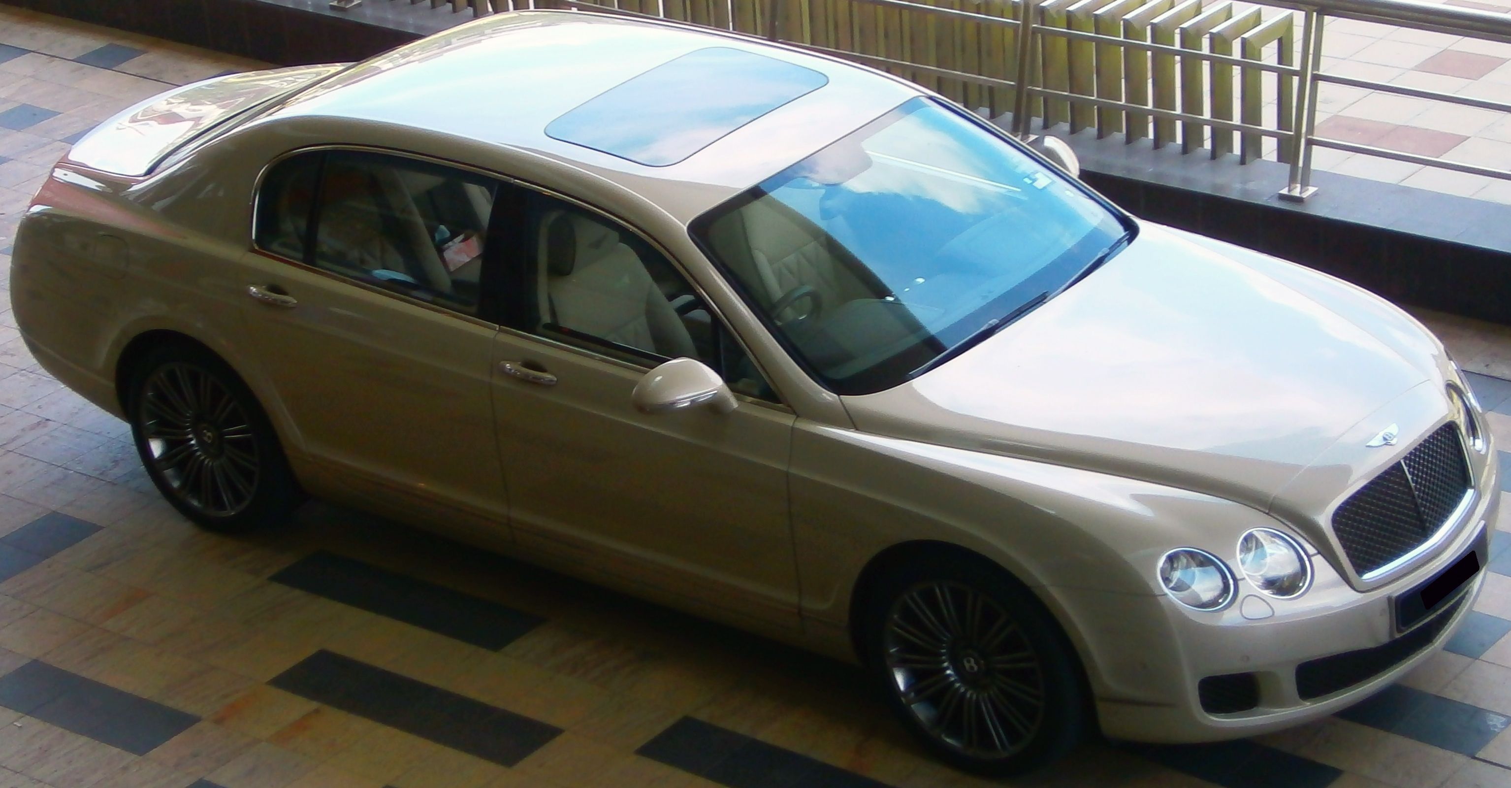 Champagne 2011 Bentley Continental Flying Spur saloon, high front three-quarter view