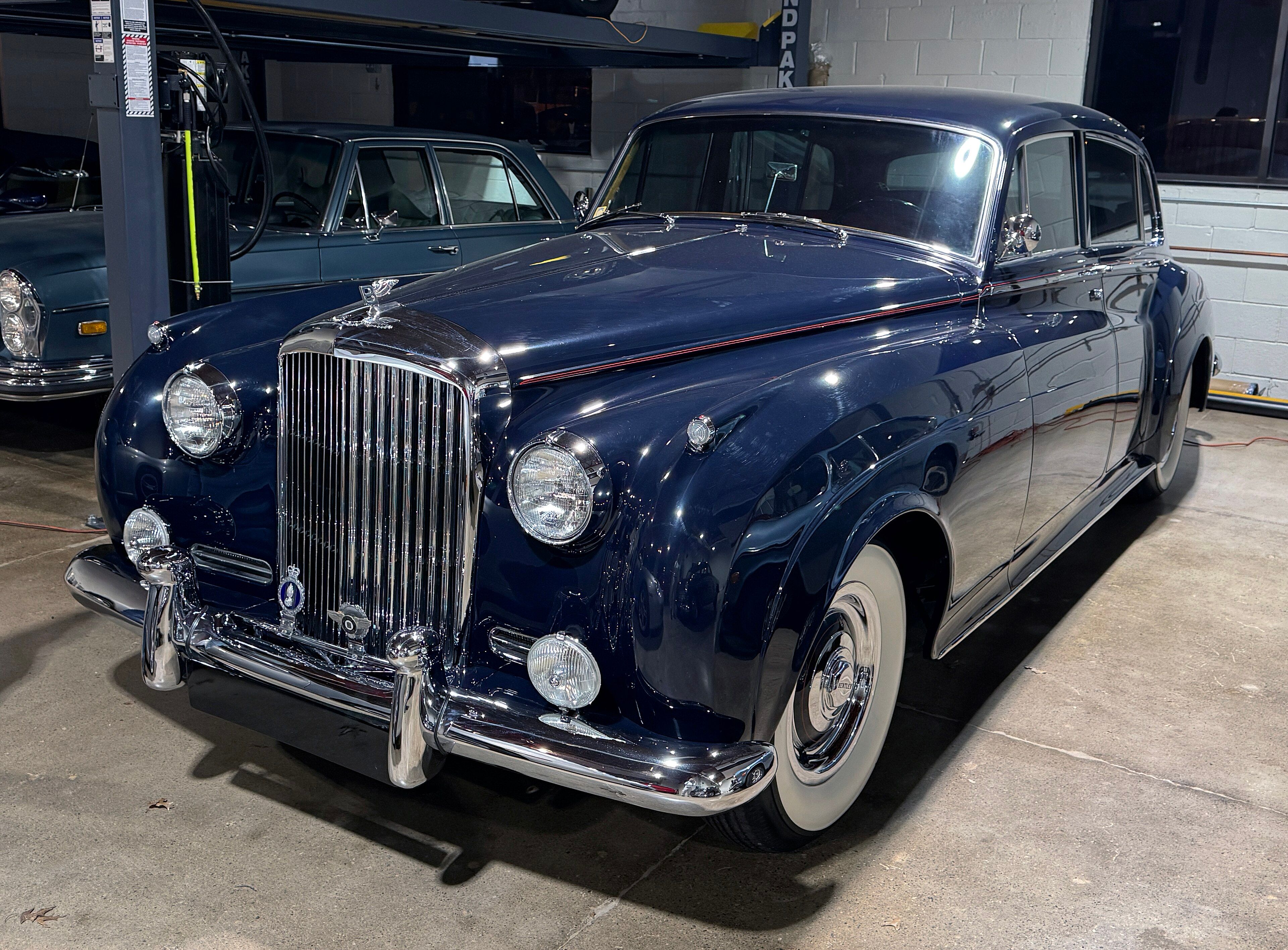 Dark blue 1959 Bentley S1 Park Ward division saloon, front-left view