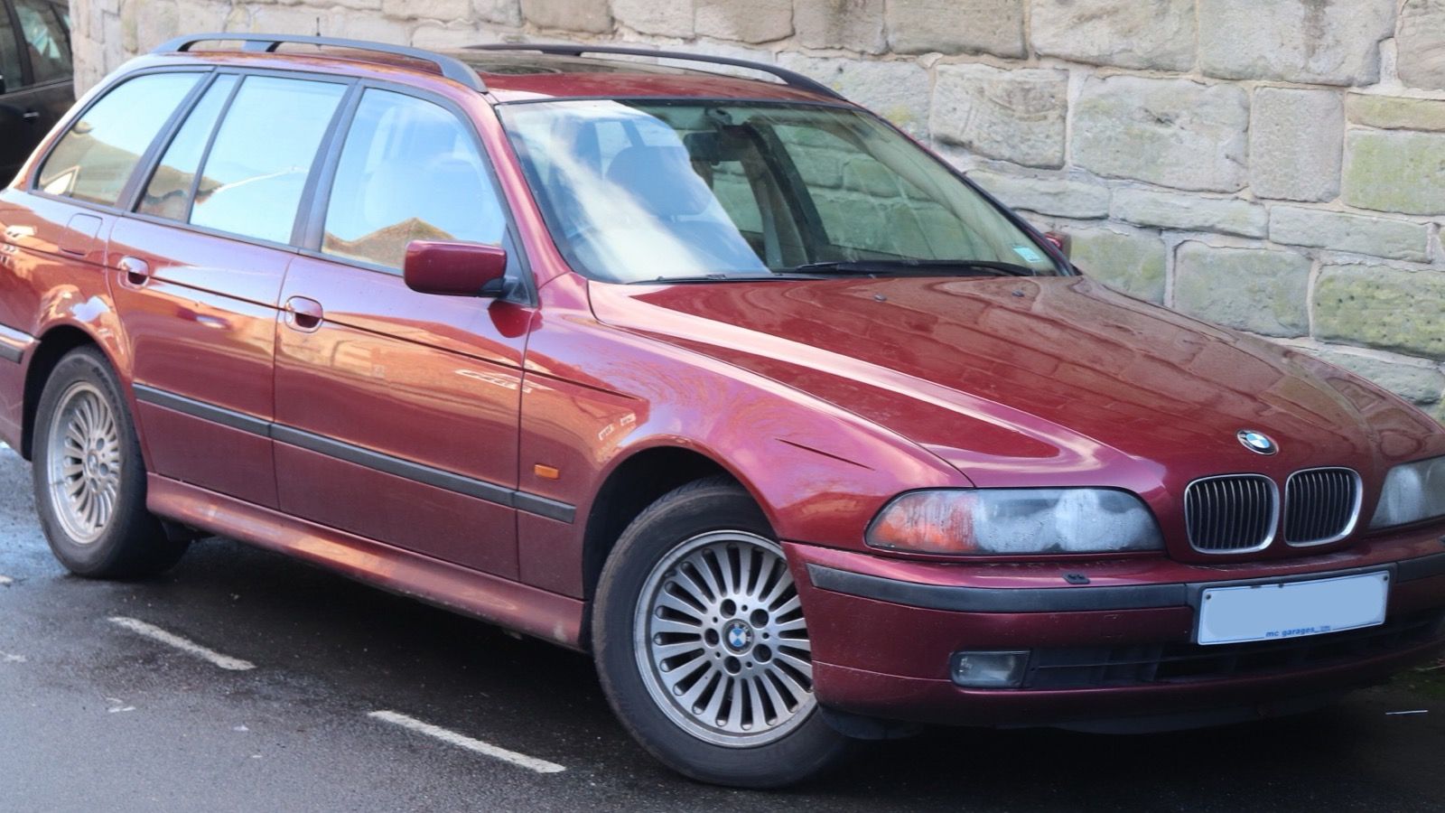 Red 1998 BMW 540i Touring (E39) wagon, front three-quarter view