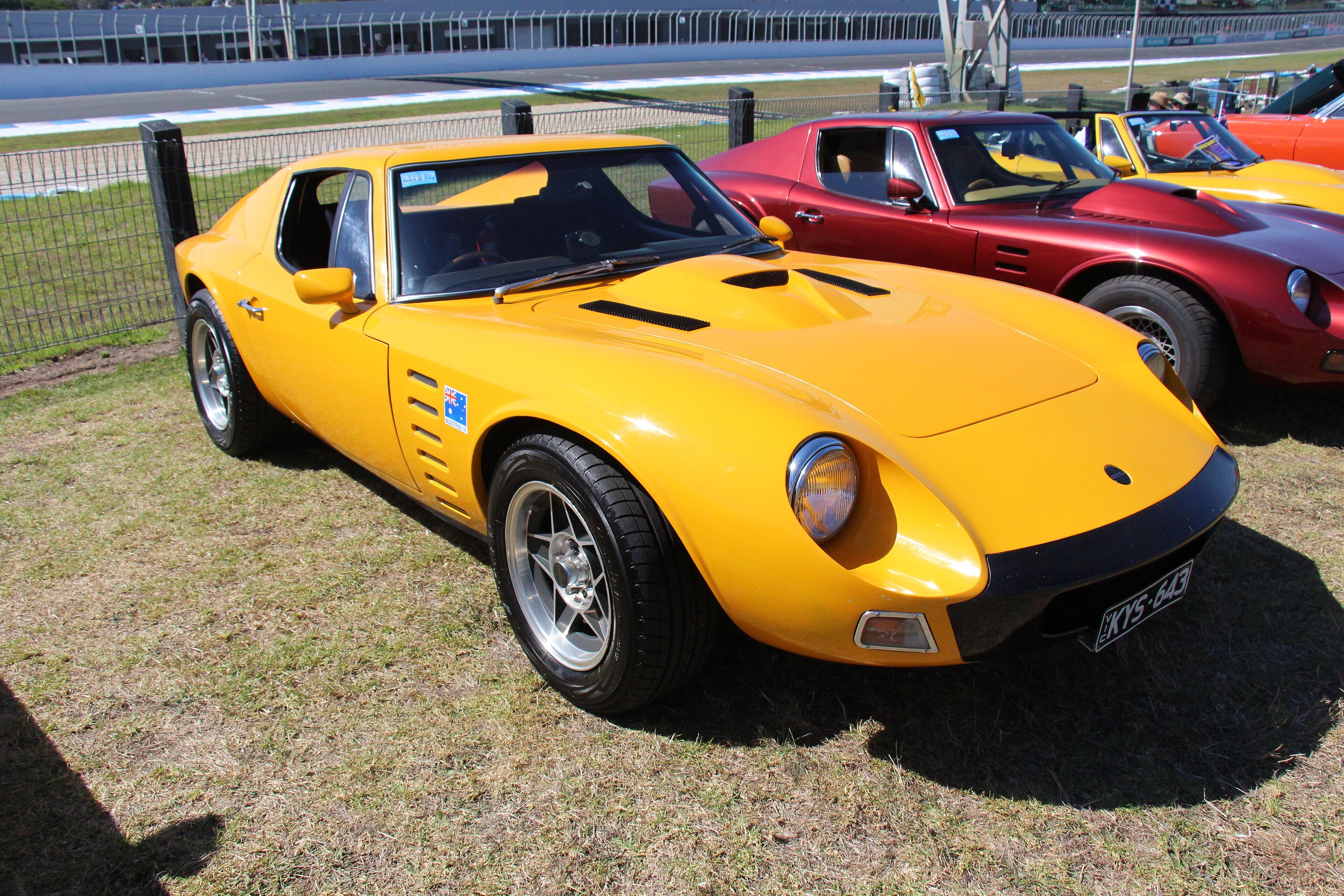 Orange-yellow 1970 Bolwell Nagari Mk VIII coupe, front three-quarter view