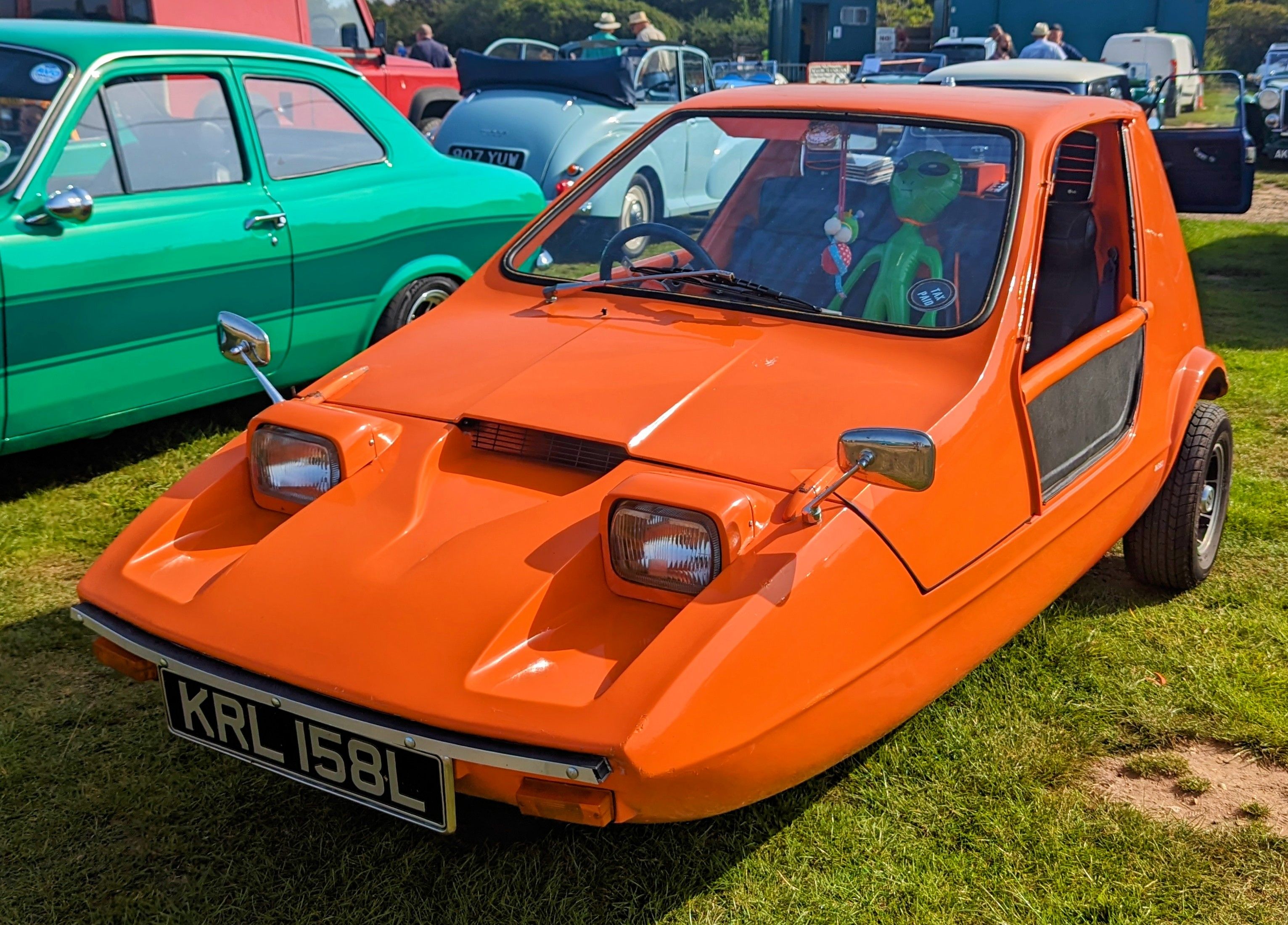 Tangerine orange 1973 Bond Bug 700 wedge-shaped three-wheeler, front three-quarter view