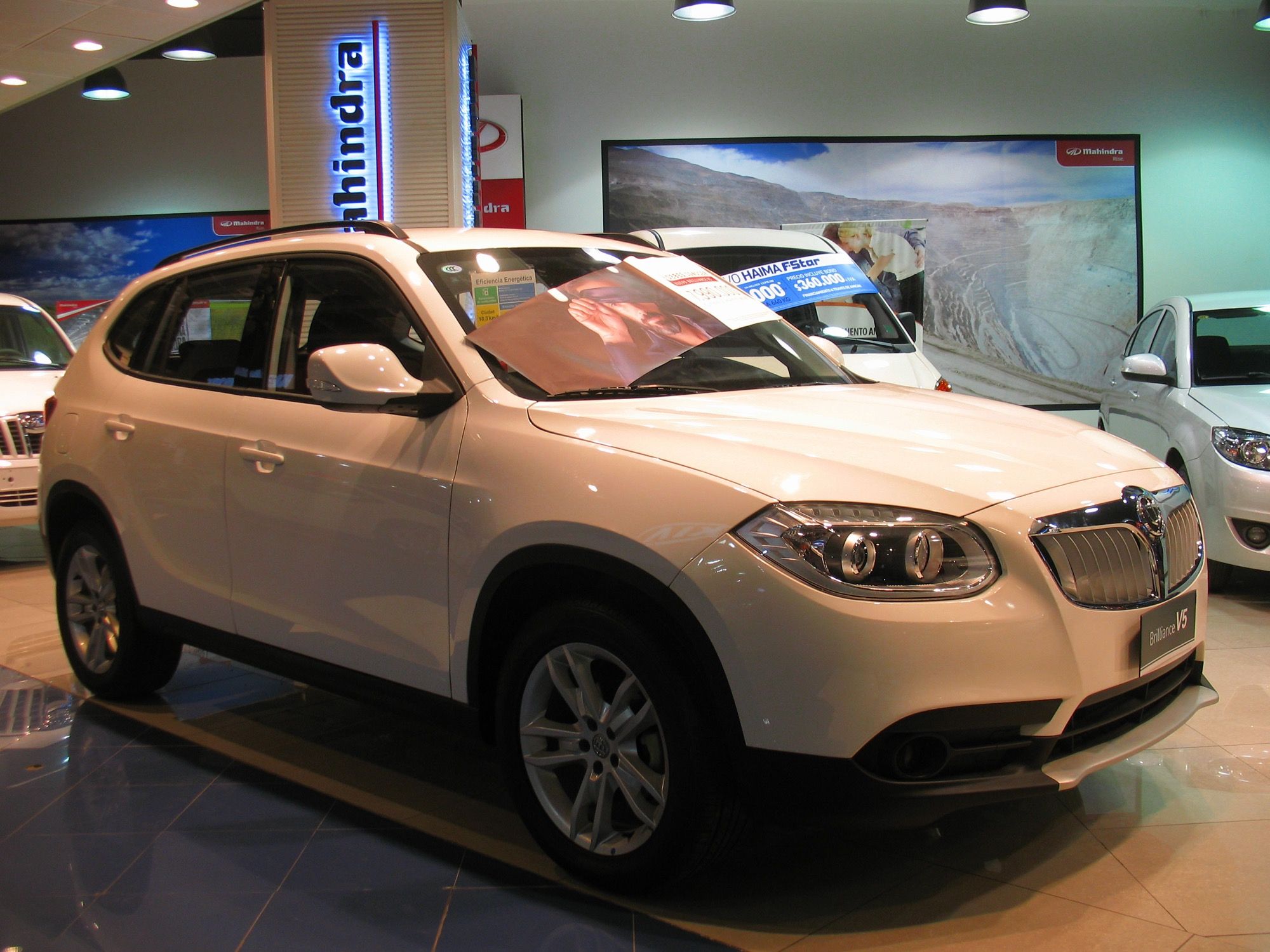 White 2013 Brilliance V5 1.6 Comfortable in a showroom, front three-quarter view