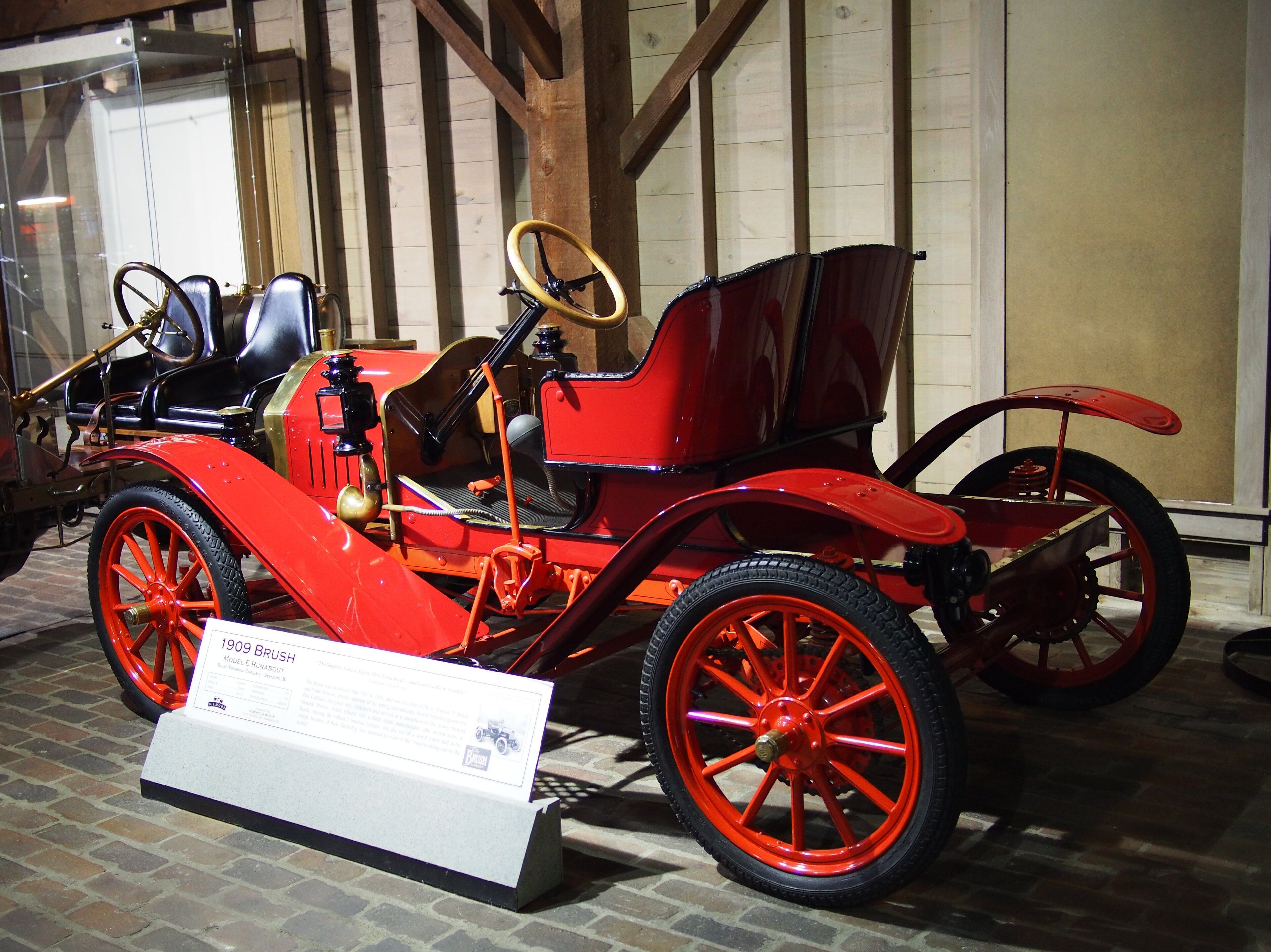 Red 1909 Brush Model E Runabout on museum display, front three-quarter view