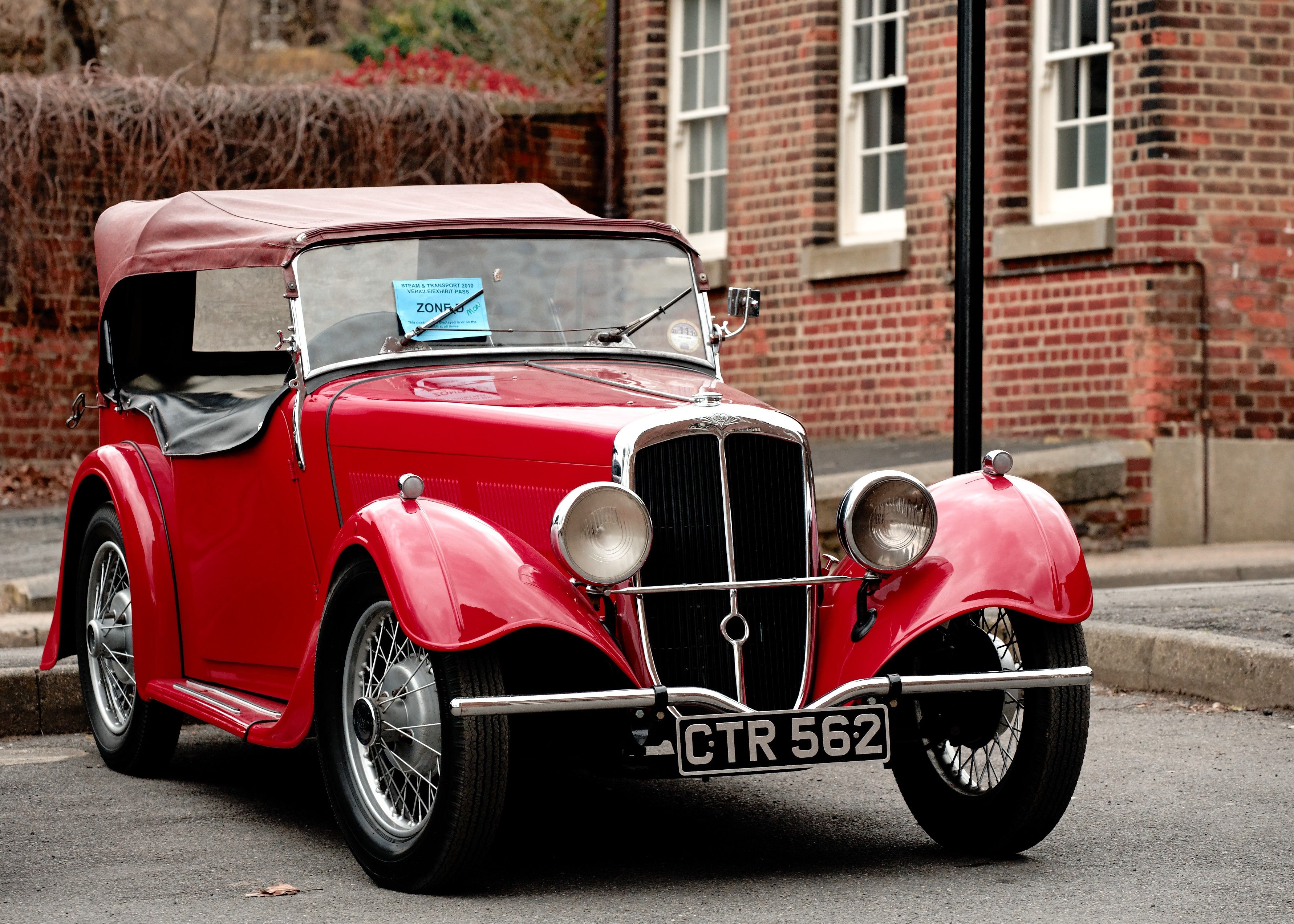 Red 1939 BSA Scout drophead coupé, front three-quarter view