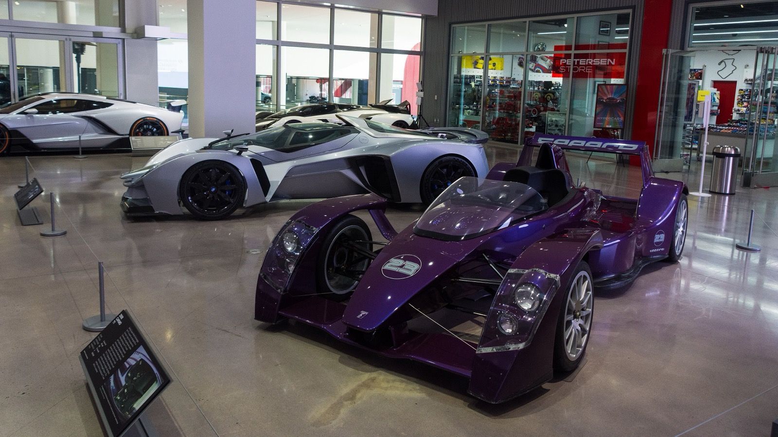 Purple Caparo T1 on museum display, front three-quarter view showing exposed suspension and open cockpit