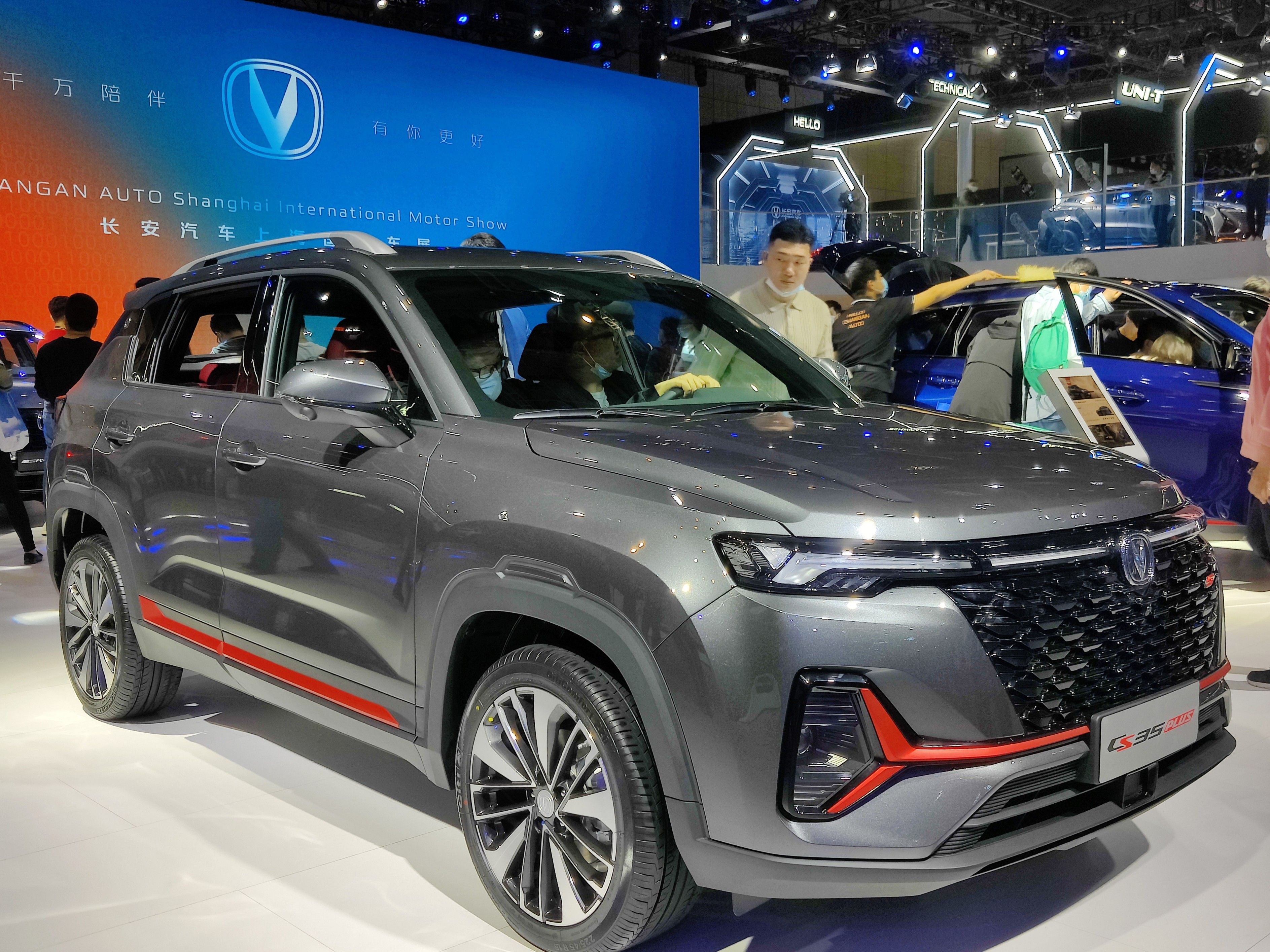 Grey 2021 Changan CS35 Plus facelift on a motor show stand, front three-quarter view