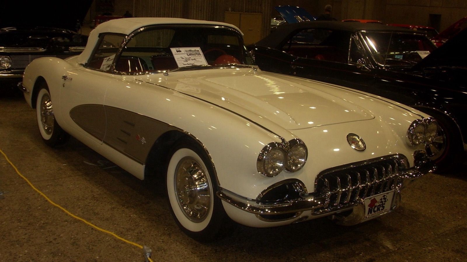 1958 Chevrolet Corvette, C1 first generation — white with silver cove and quad headlights, front three-quarter view