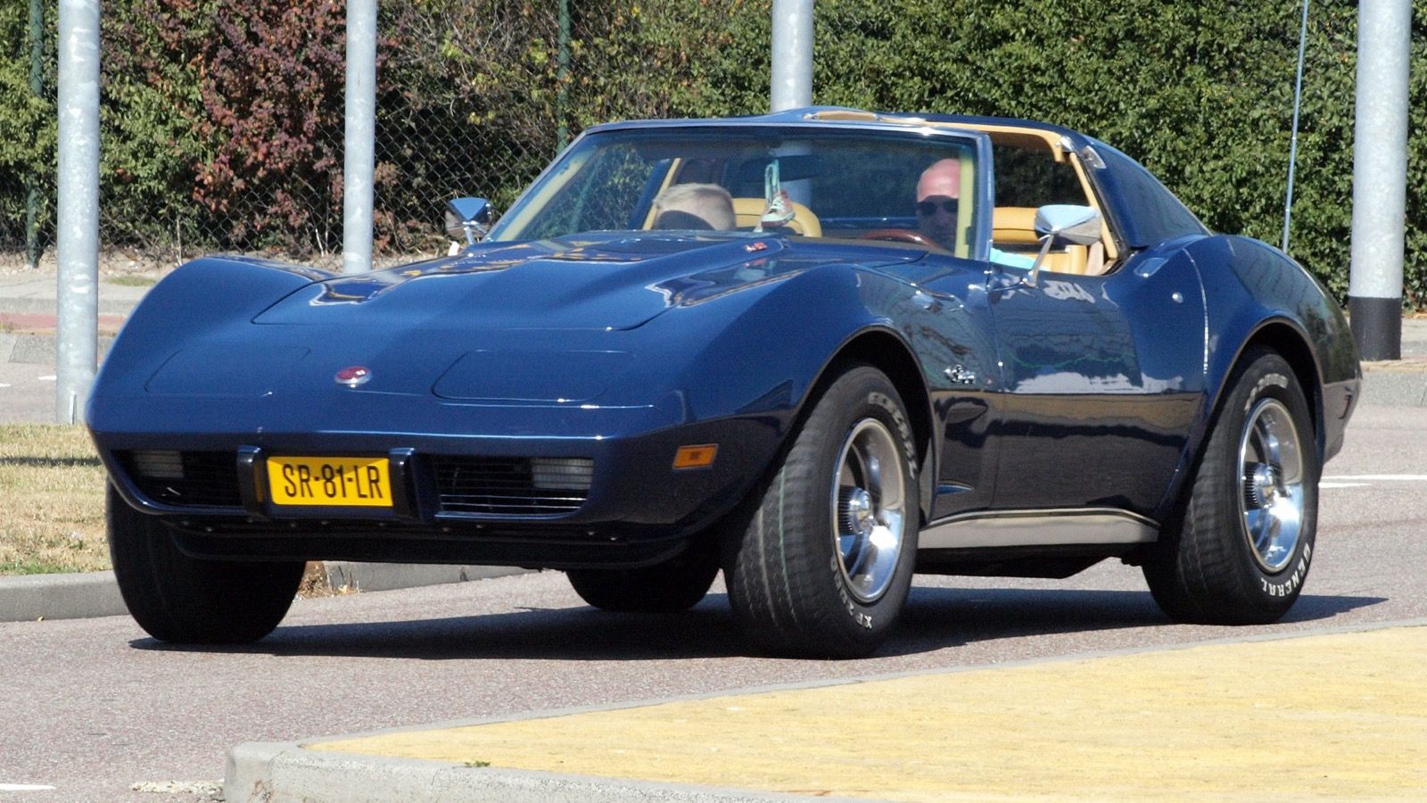 1975 Chevrolet Corvette, C3 third generation — dark blue coupe with soft bumpers, front three-quarter view