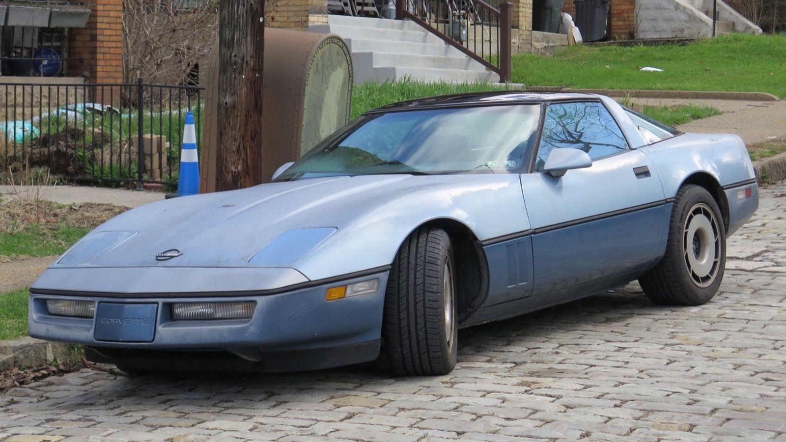 1984 Chevrolet Corvette, C4 fourth generation — light blue coupe, front three-quarter view