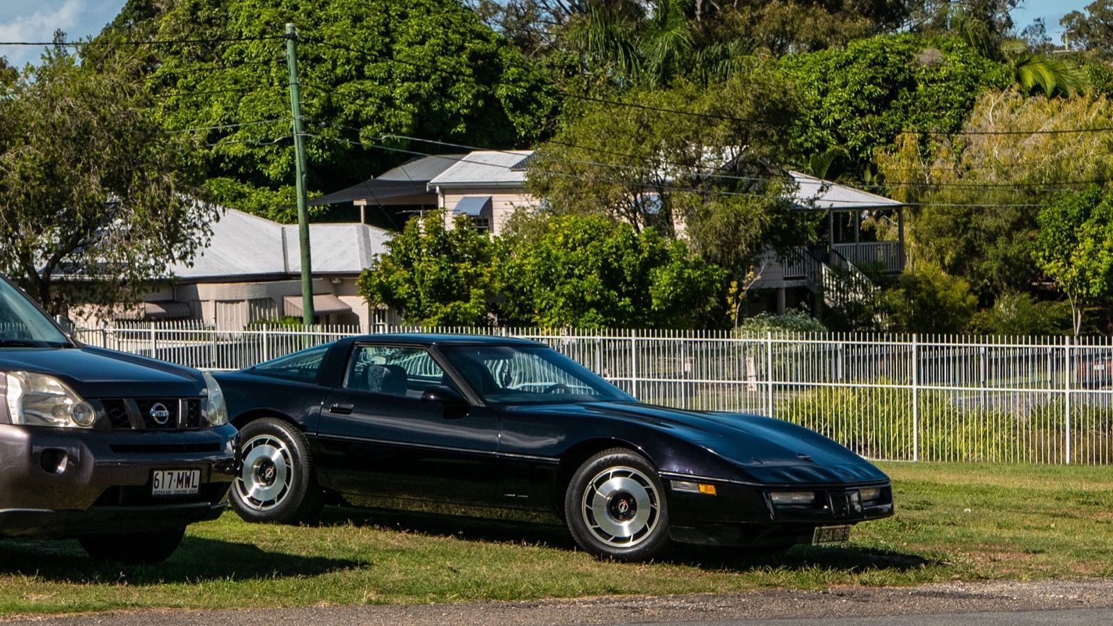 1985 Chevrolet Corvette, C4 fourth generation — black coupe, left side profile
