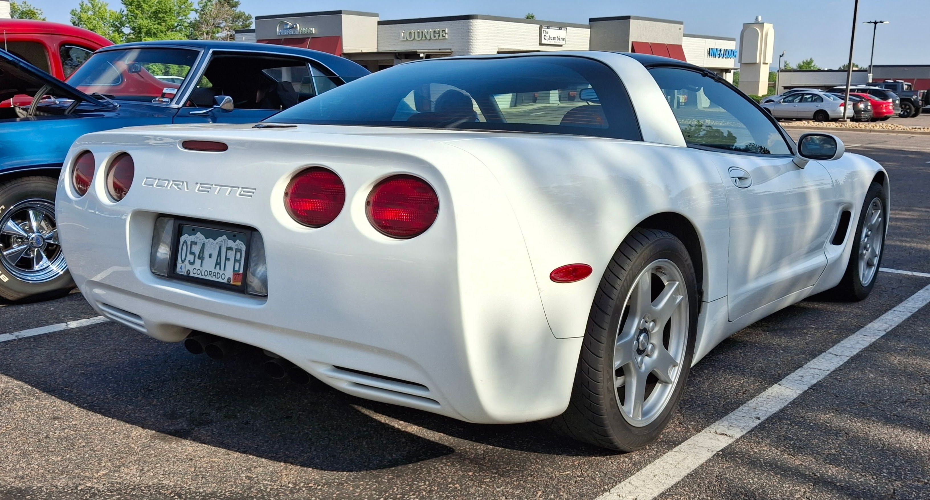 1997 Chevrolet Corvette — stock C5 coupe in white, rear three-quarter view