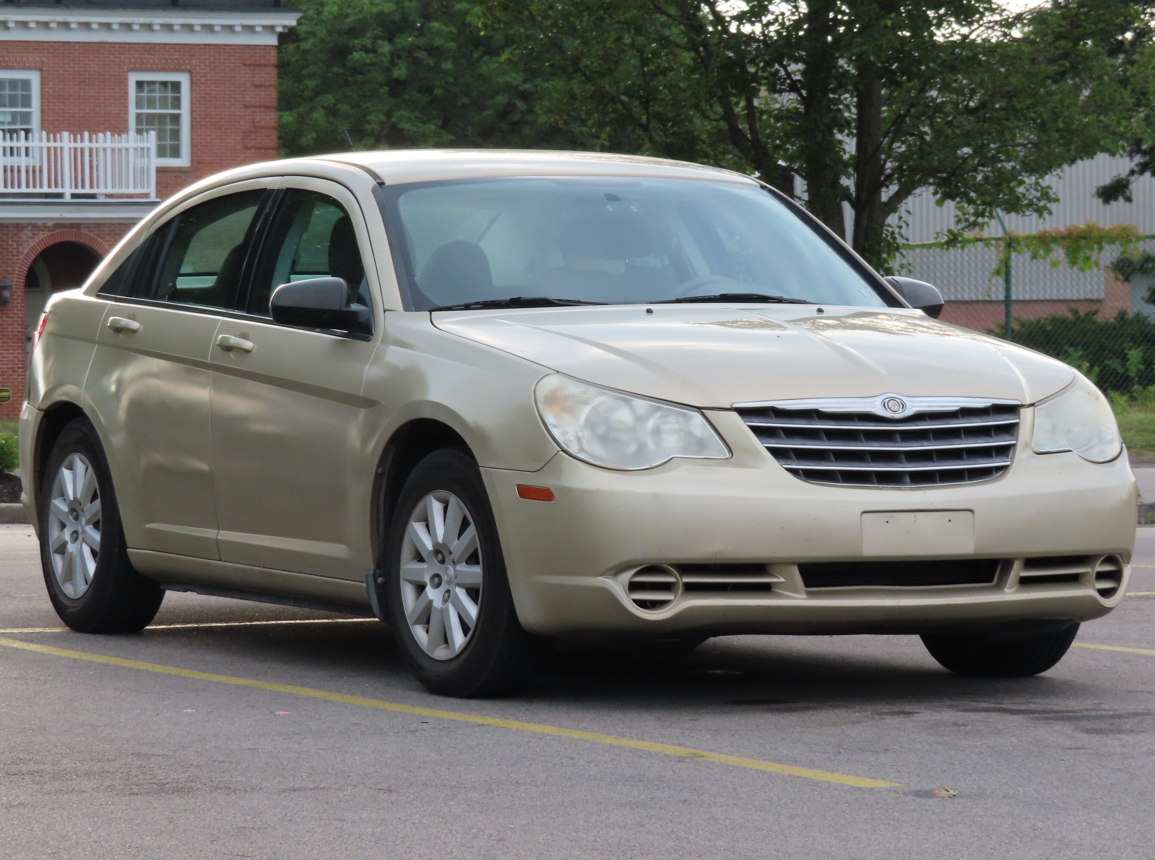 Gold 2010 Chrysler Sebring Touring sedan, front three-quarter view