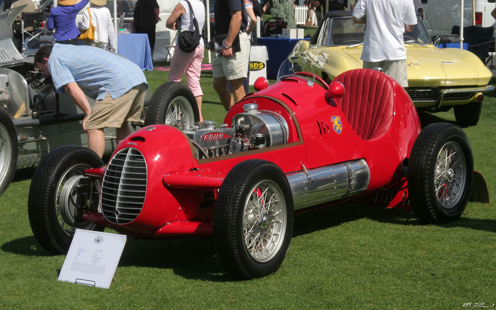 Red Cisitalia D46 single-seat racing car, front three-quarter view with exposed engine