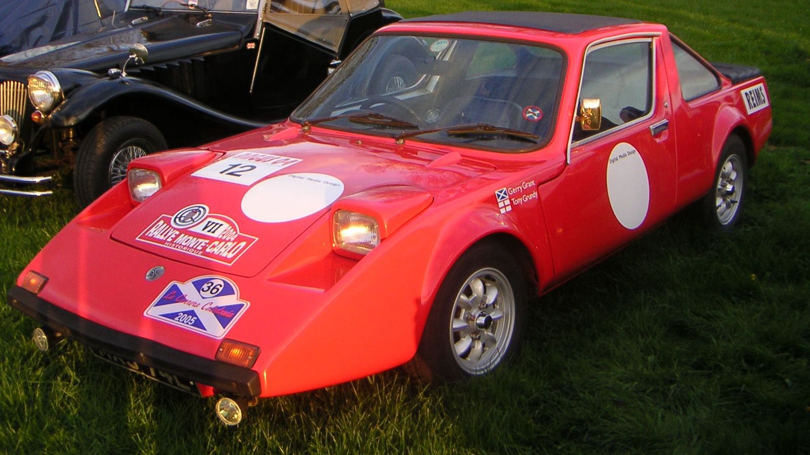 Red 1972 Clan Crusader in historic rally livery, front three-quarter view