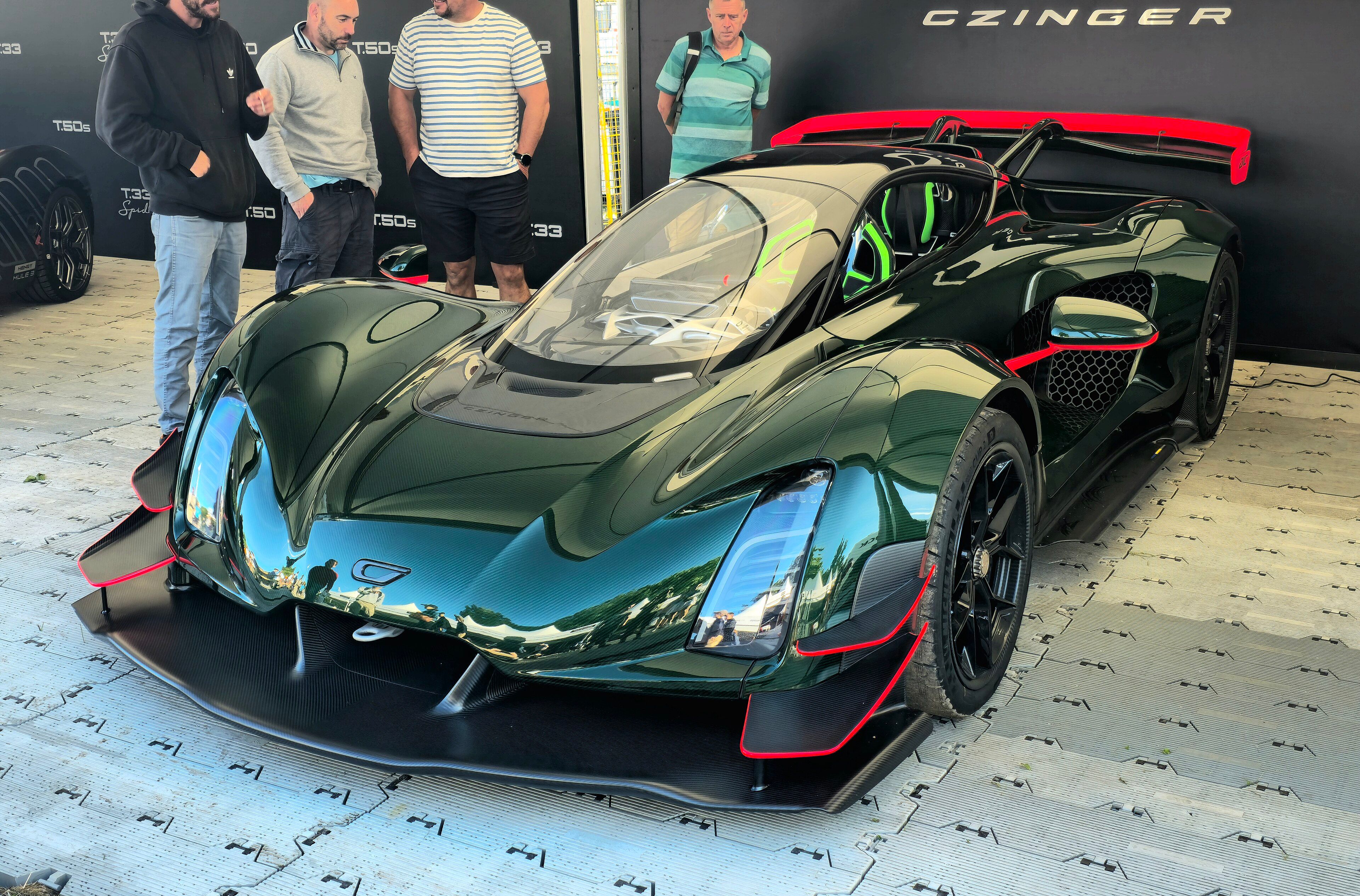 Dark green Czinger 21C hypercar on display, front three-quarter view
