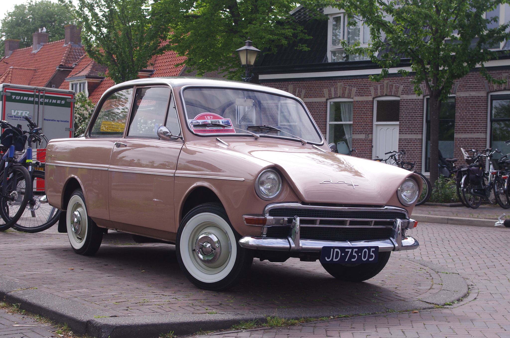 Pink 1962 DAF 30 Daffodil two-door saloon, front three-quarter view