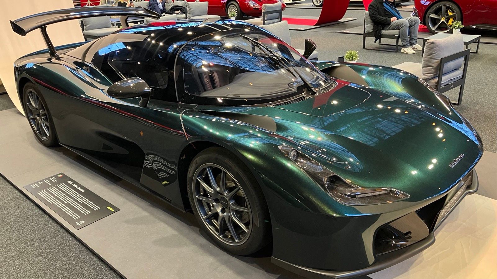 Dark-green 2020 Dallara Stradale berlinetta with rear wing, front three-quarter view