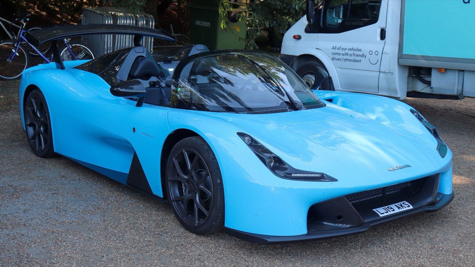 Light-blue Dallara Stradale barchetta with rear wing, front three-quarter view