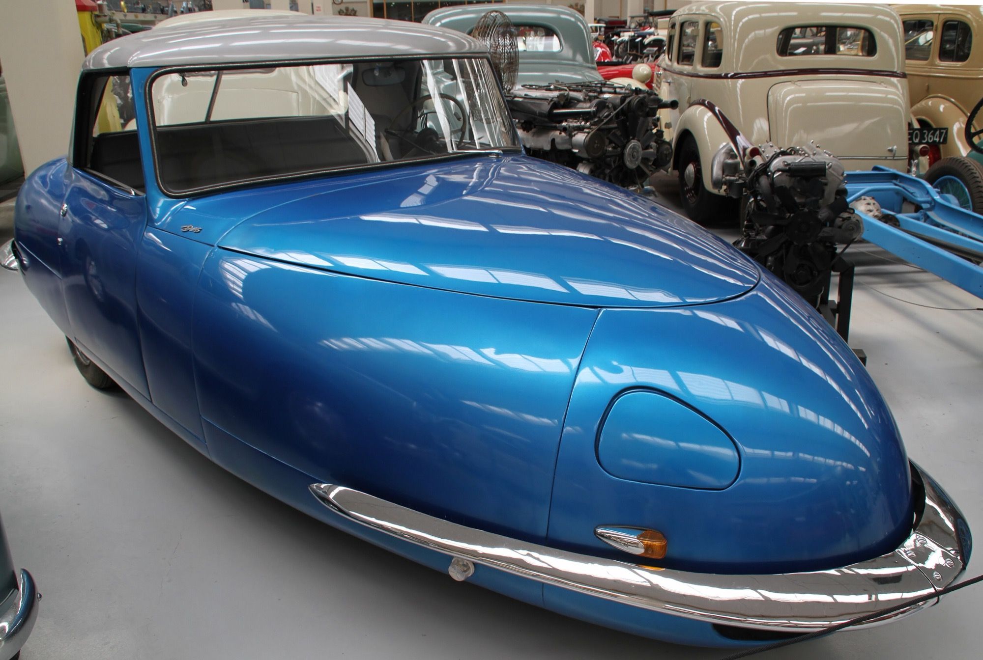 Blue 1949 Davis Divan three-wheeler with hardtop, front three-quarter view, on museum display