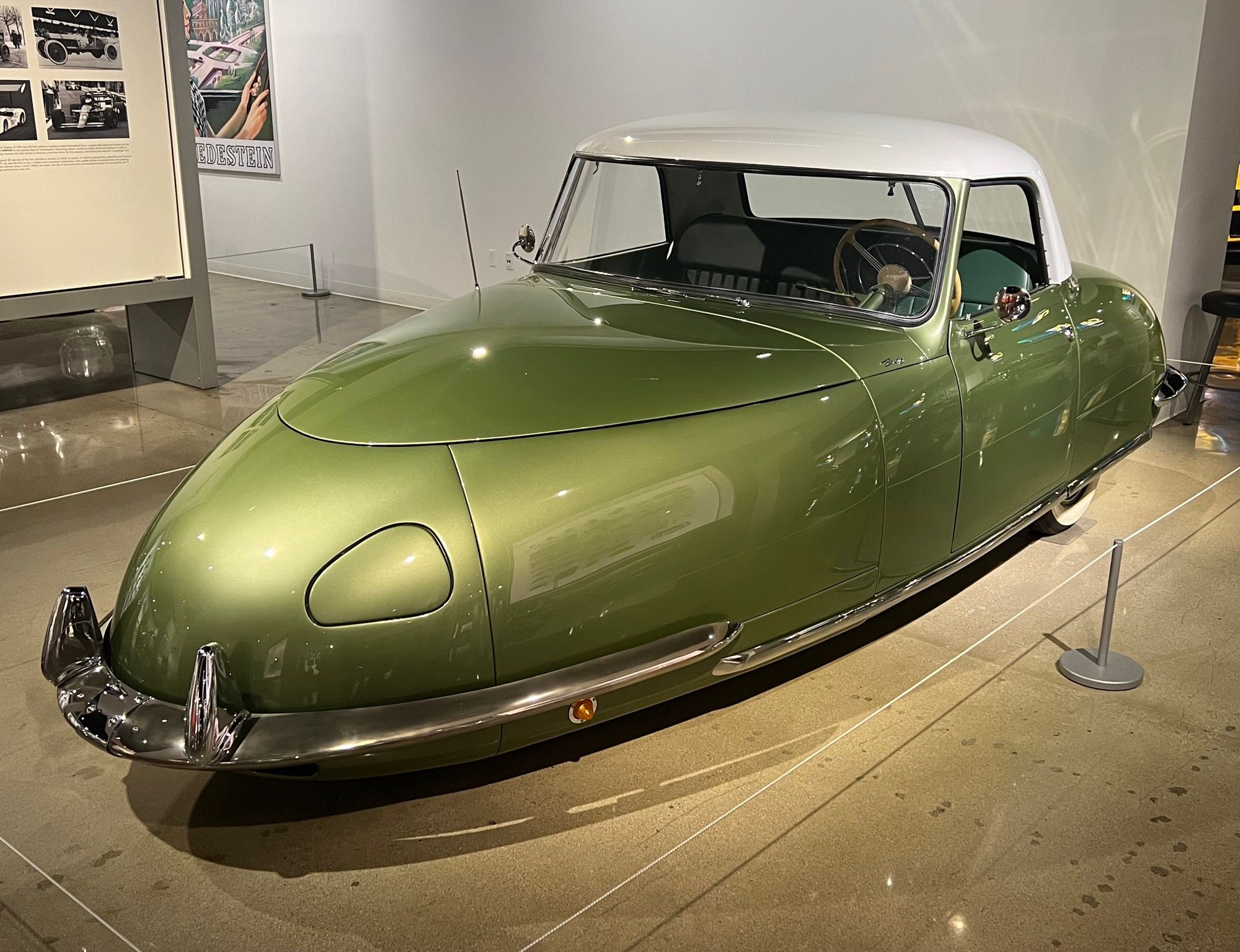 Green and white 1948 Davis Divan three-wheeled convertible, front three-quarter view, at the Petersen Automotive Museum