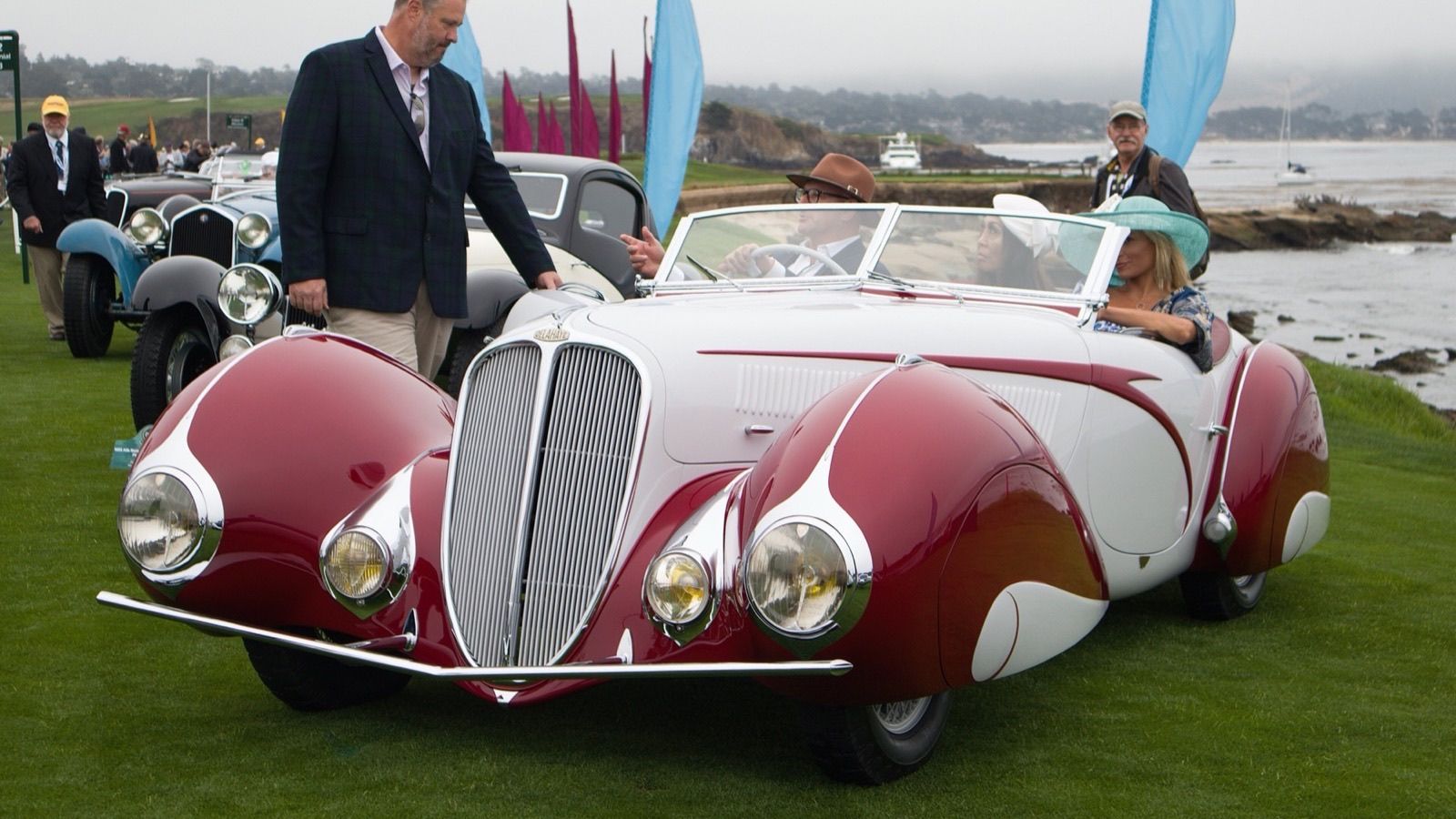Red and white coachbuilt Delahaye 135 roadster, front three-quarter view