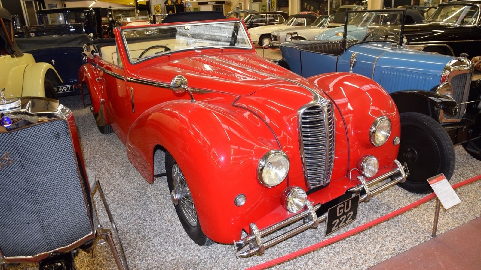 Red 1939 Delahaye 135M cabriolet on museum display, front three-quarter view