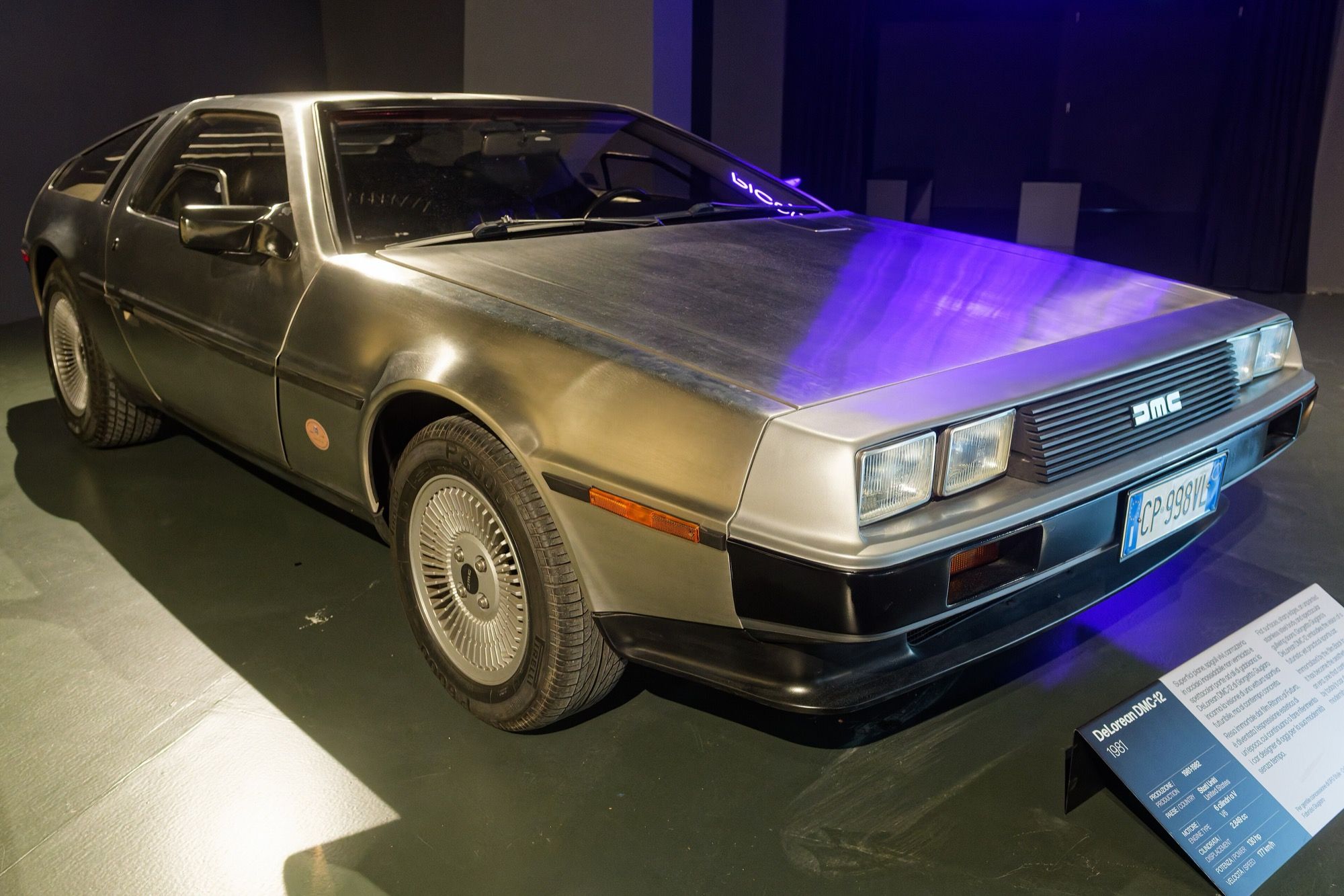 Silver 1981 DeLorean DMC-12 stainless-steel coupe, front three-quarter view on museum display