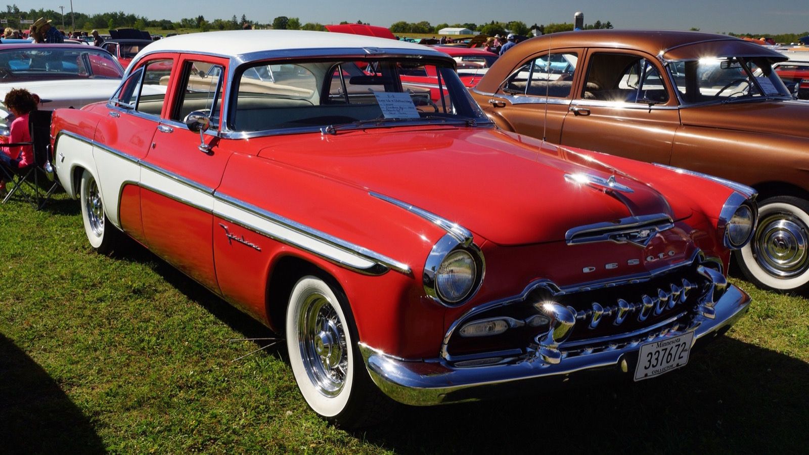Red and white 1955 DeSoto Firedome, front three-quarter view