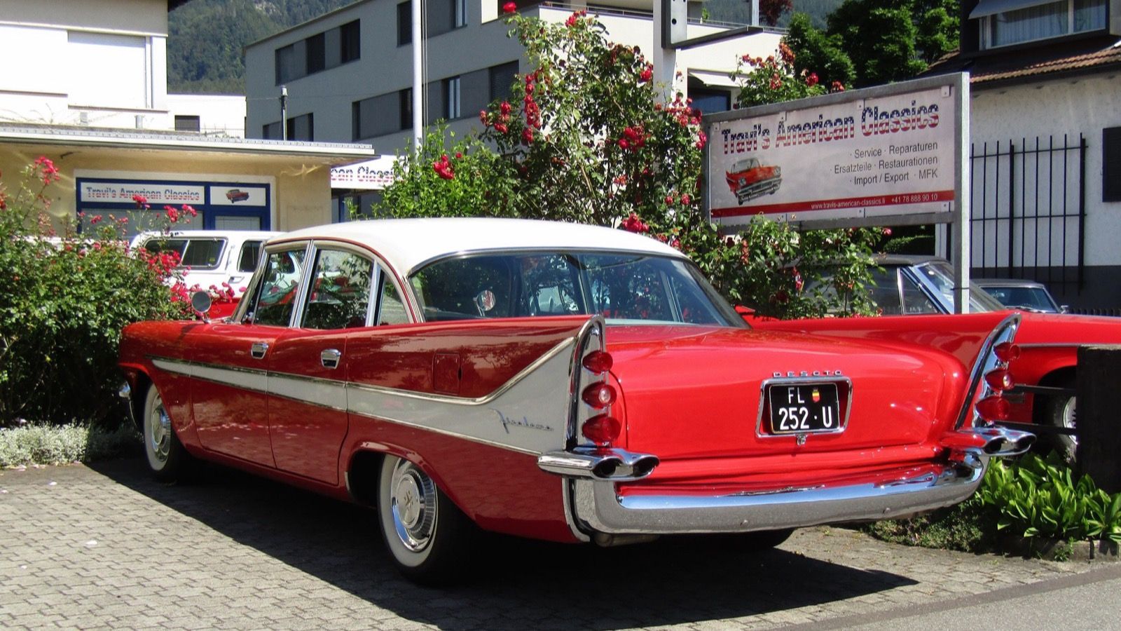 Red and white 1958 DeSoto Fireflite sedan, rear three-quarter view