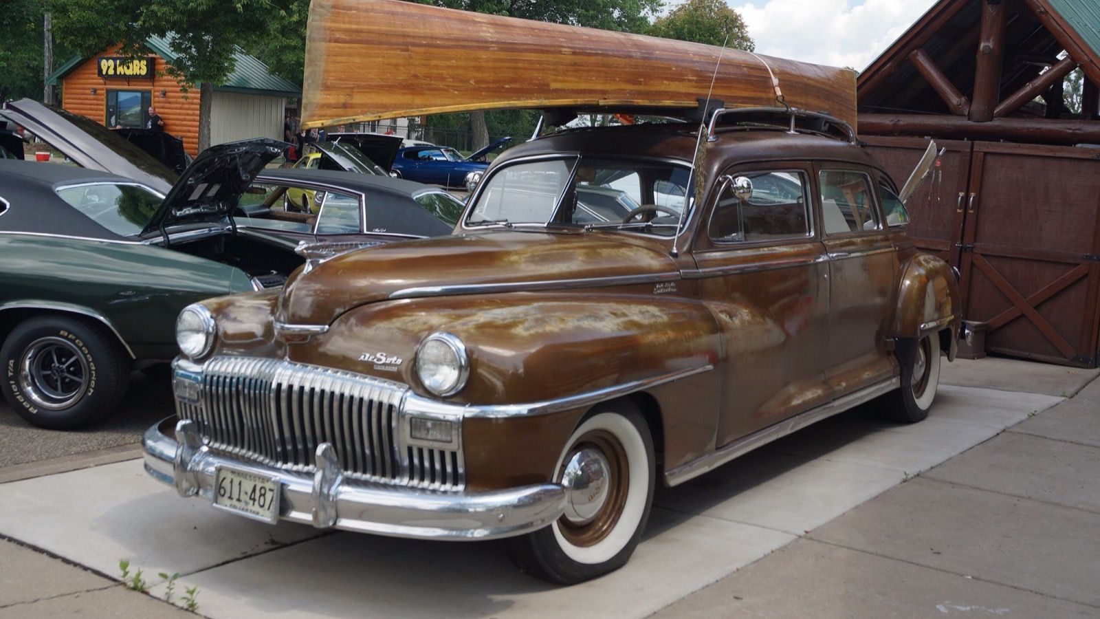 Brown 1947 DeSoto Suburban with roof rack, front three-quarter view