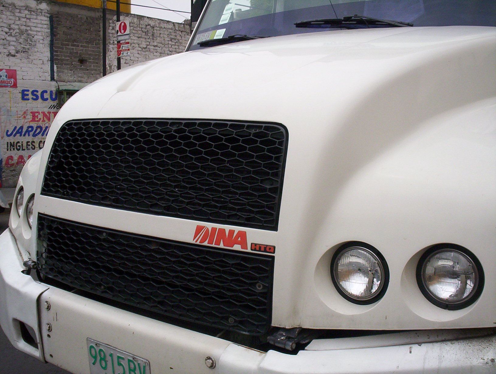 White DINA HTQ heavy truck, front view showing the DINA HTQ grille badge and aerodynamic hood