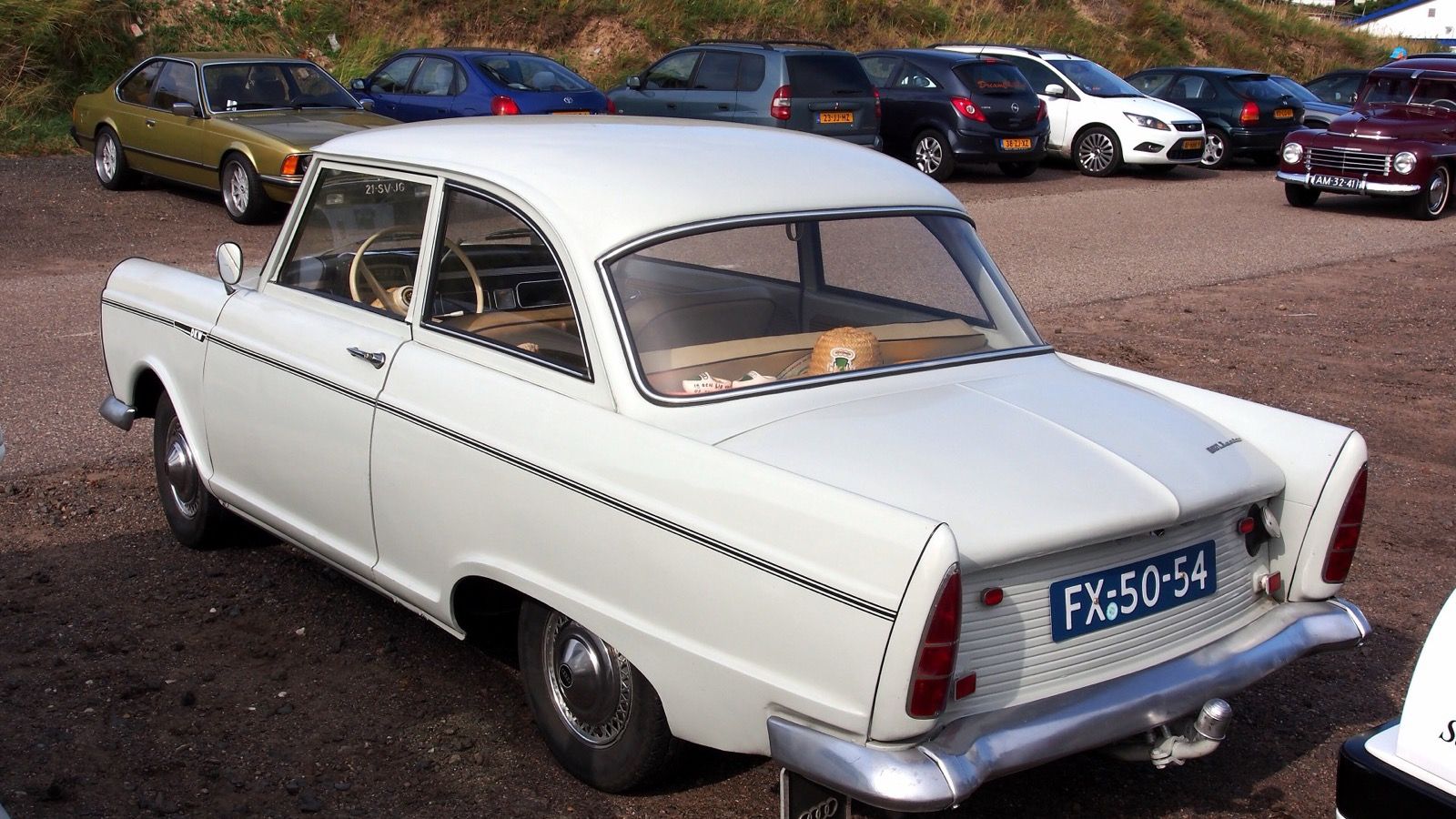 White 1961 DKW Junior two-door sedan in a car park, rear three-quarter view