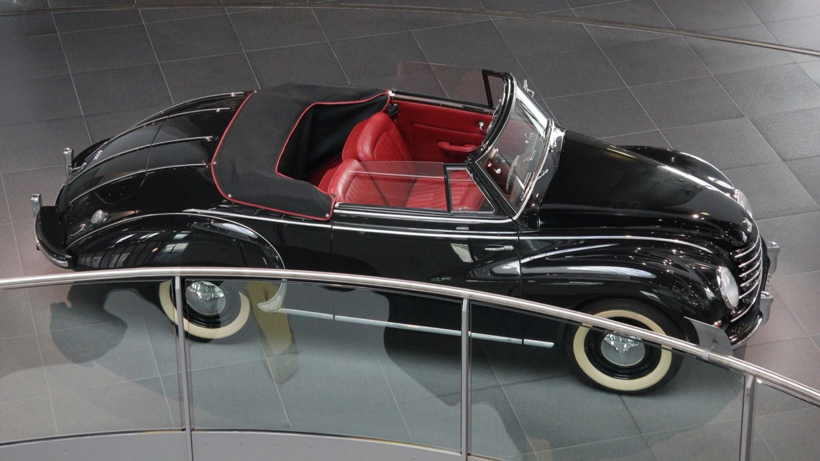 Black 1953 DKW F91 Karmann cabriolet with the top down, elevated side profile