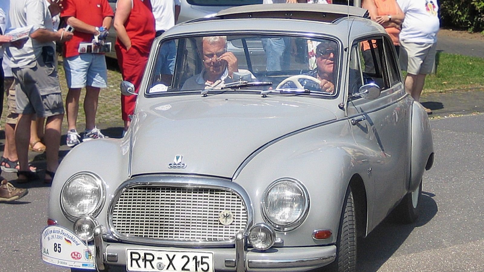 Silver 1957 DKW F93 sedan on a road rally, front three-quarter view