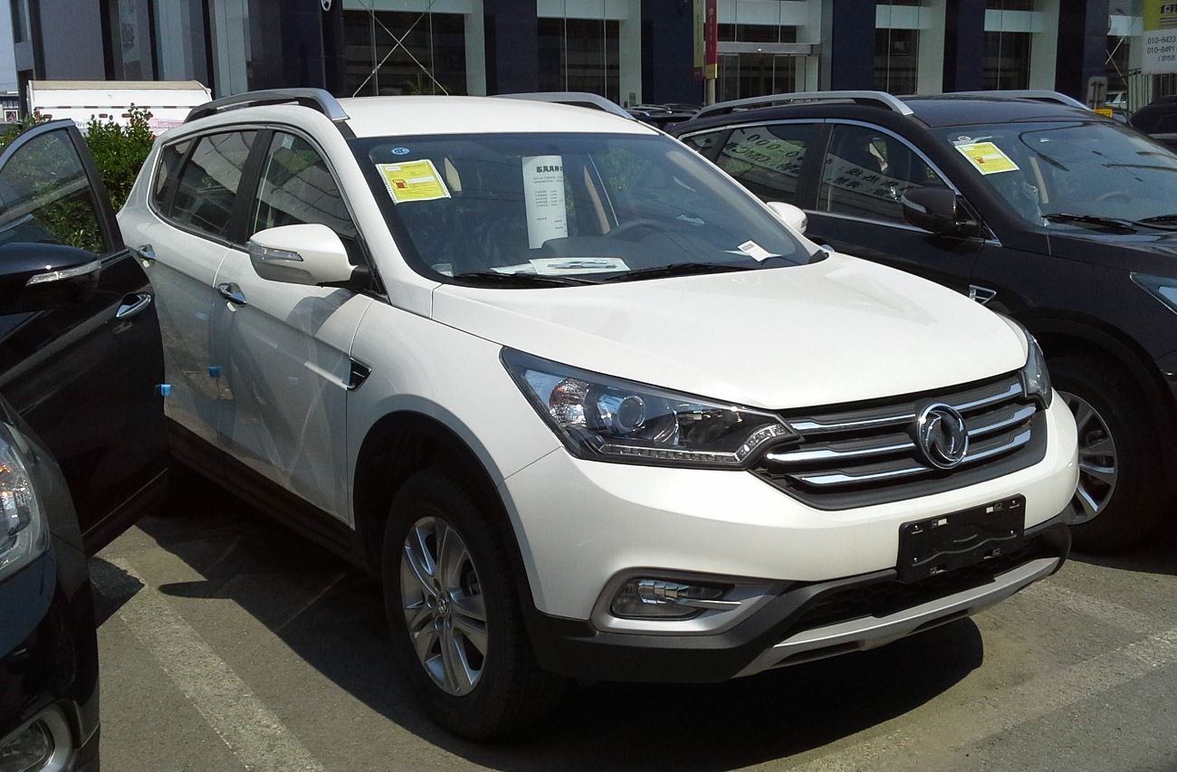 White 2015 Dongfeng Fengshen AX7 compact SUV at a Chinese dealership, front three-quarter view