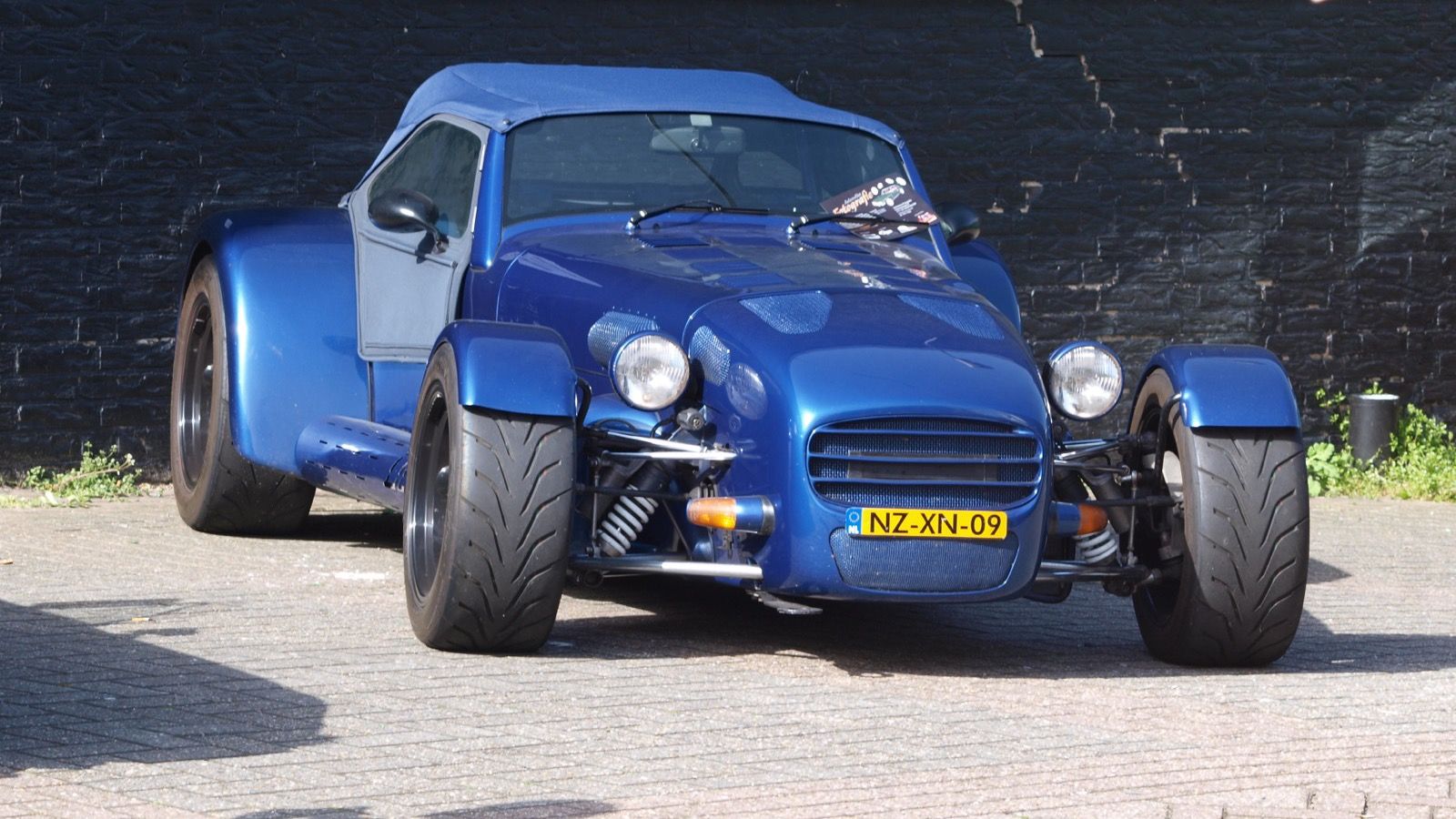 Blue 1996 Donkervoort D8 Cosworth with soft top raised, front three-quarter view
