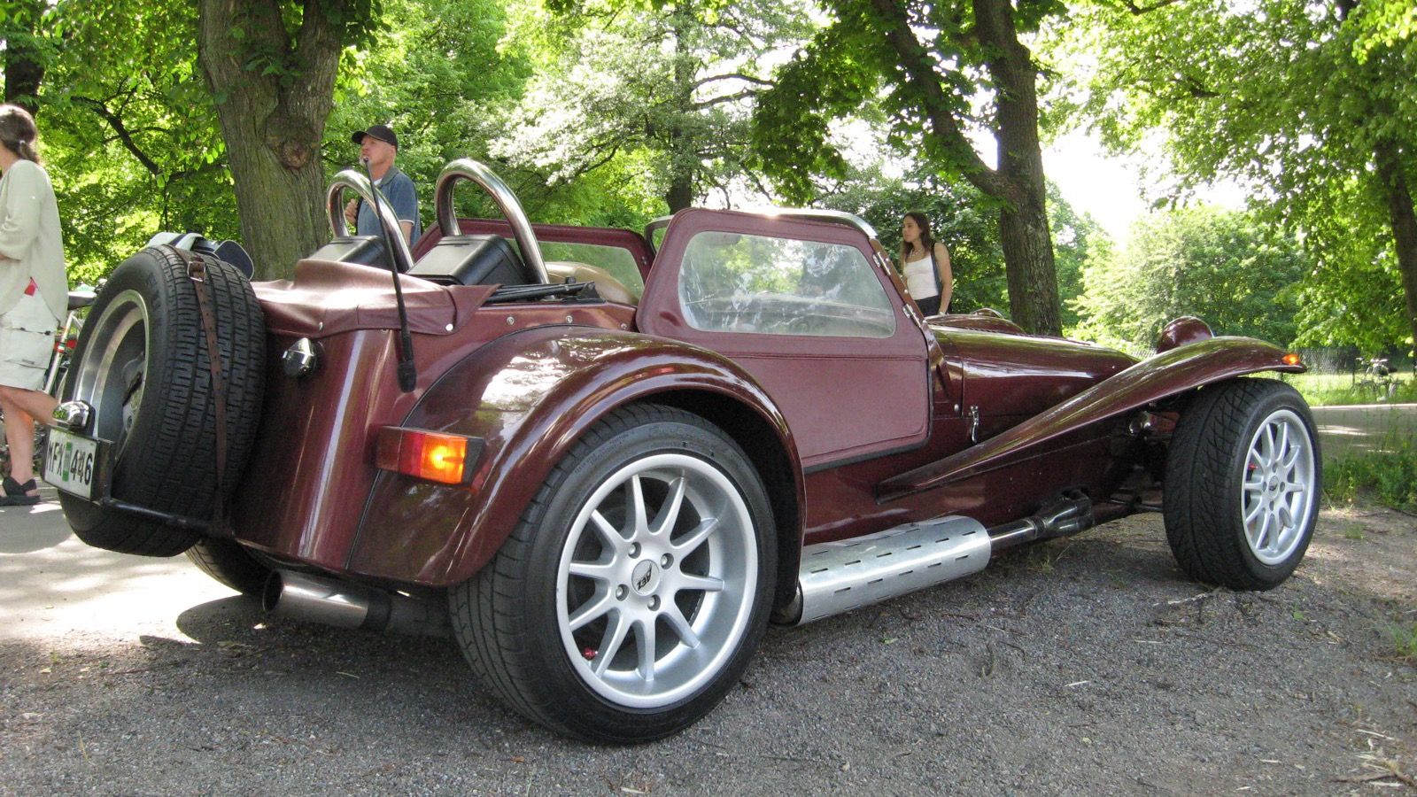 Maroon 1986 Donkervoort Super 8 roadster with rear-mounted spare wheel, rear three-quarter view