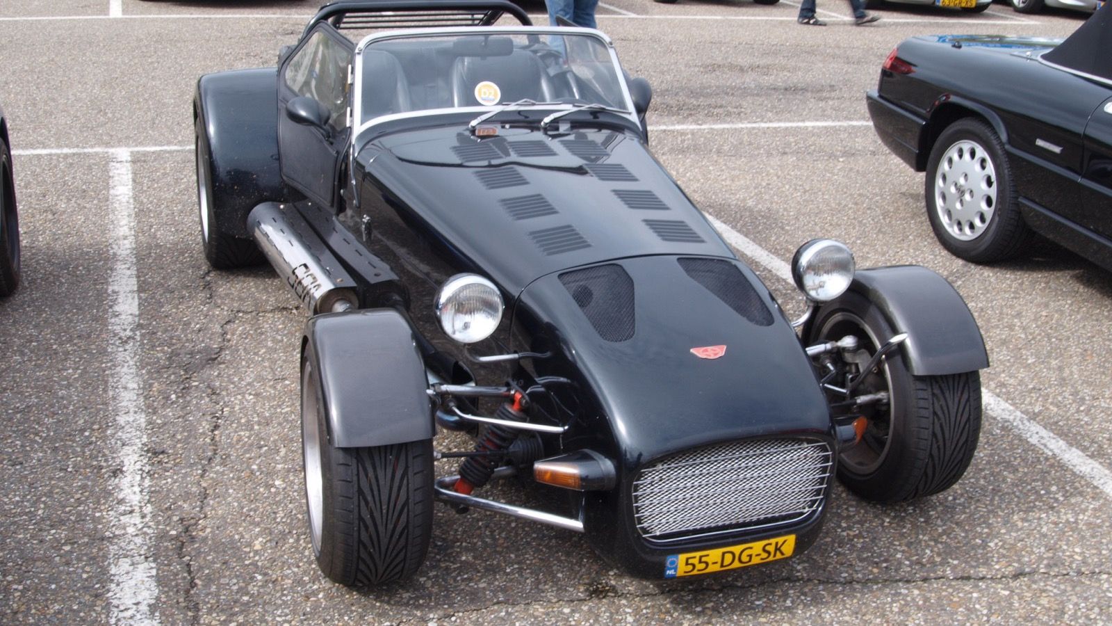 Black Donkervoort S8A roadster with cycle wings and exposed front suspension, front three-quarter view
