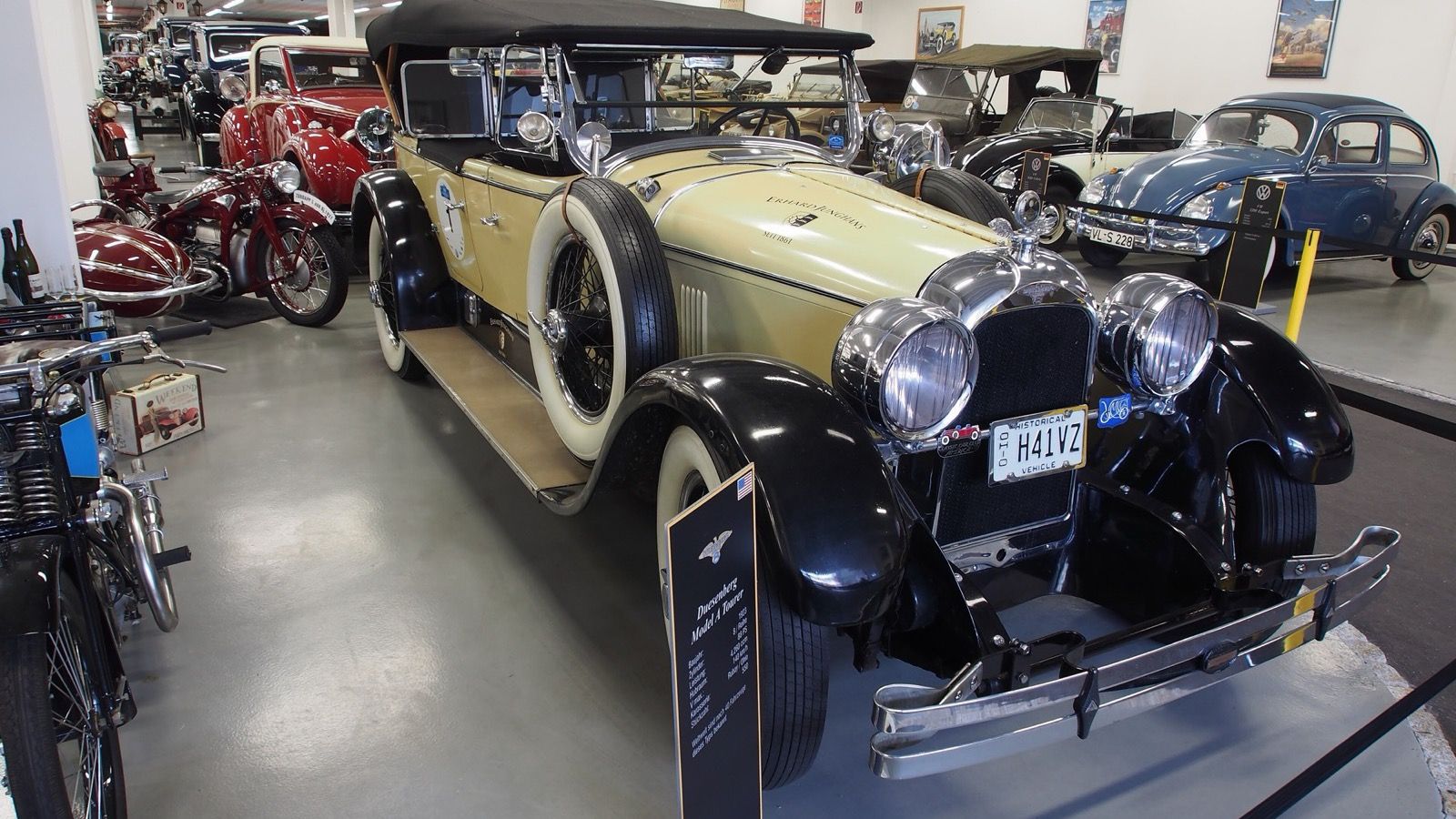 Cream and black 1923 Duesenberg Model A tourer, front three-quarter view